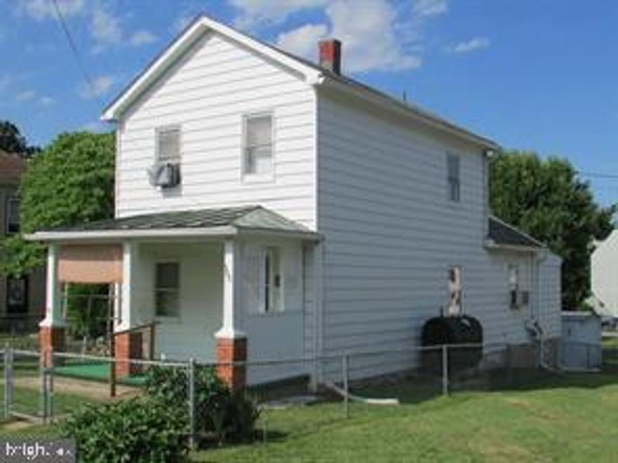 Great starter home or investment. 2 bedrooms, 1.5 baths, living room, dining room, remodeled kitchen w/Oak cabinets, enclosed back porch, beautifully landscaped corner lot w/chain link fence, and 2 storage buildings. This house has a lot of potential with a great location. Sold "As Is".