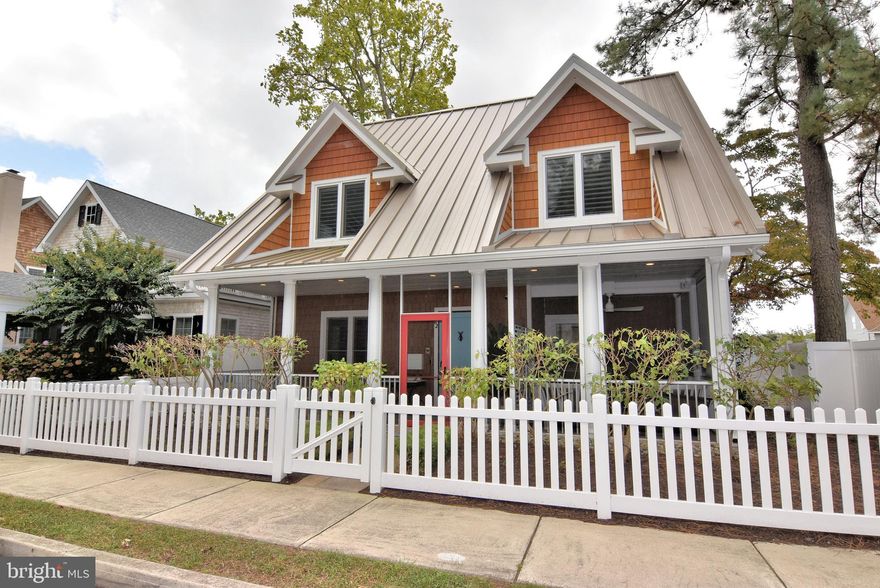This beautifully renovated 3-bedroom, 2.5-bath home is perfectly situated in the heart of downtown Rehoboth Beach—just four blocks from the beach and boardwalk, steps from many of the area’s most popular restaurants, and only two blocks from the award-winning Rehoboth Beach Farmers Market. Remodeled in 2025, the home blends timeless coastal charm with high-end finishes and modern amenities throughout. The renovation included a complete overhaul of all three bathrooms, new quartz countertops in the kitchen, and custom shiplap detailing that adds warmth and character while preserving the home's original appeal. The thoughtfully designed layout features a spacious first-floor primary suite with a large ensuite, an open-concept kitchen and living area, two screened porches, second-floor deck, and a beautifully landscaped garden patio. For rinsing off after a beach day, enjoy the stylish outdoor shower—complete with a playful surfboard backdrop. Interior highlights include triple-paned European-style INTUS hurricane windows, radiant floor heating, and reclaimed whitewashed oak ceilings in all bedrooms and the den. Additional upgrades include solar panels, a Racine 50-year metal roof, an electric car charger, a whole-house sprinkler system, custom plantation shutters, and automatic blackout shades in the primary bedroom. Upstairs offers two spacious bedrooms, a full bathroom, a cozy sitting area, and a convenient laundry space, while a detached outbuilding provides a second laundry area, mechanical room, and generous storage for bikes and beach gear. The first floor is wheelchair accessible, ensuring ease of use for all. With its unbeatable location, thoughtful layout, and exceptional upgrades, this rare gem offers the perfect blend of charm, comfort, and modern living in downtown Rehoboth Beach.