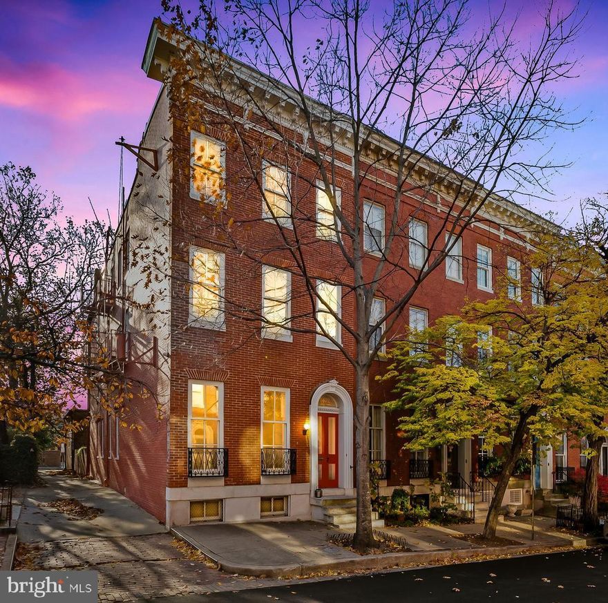 Create the life you love in quintessential Bolton Hill Victorian. This elegant end-of-group townhome situated on the 1400 block of Bolton Street is a rare find. From top to bottom, each detail has been thoughtfully considered to ensure this home is the perfect place to live, work and play. Indoors and out, this home offers all that a modern city dweller desires. Outside, the two-story carriage house which includes two car parking, and an EV charger offers the next owner the unique opportunity to create an additional living space in the upper loft.  Inside, the homes' main level graciously blends historic warmth and modern functionality without sacrificing utility or style. The generously proportioned living room features oversized windows with lovely views. A separate and spacious dining room features south facing windows and ensures hosting bright and sunny brunches or candlelight dinners will always be a delight. The custom kitchen features a well-designed cooking area with ample counter space that is sure to spark joy in the serious (or not so serious) chef! The kitchen island provides a perfect perch to keep the cook company or to enjoy an informal meal. The welcoming seating area overlooks the enclosed rear courtyard garden. Upstairs, a private and tranquil oasis awaits your enjoyment. The second floor features a generously proportioned primary suite with an ensuite bath and ample closet space. The library/ den features custom cabinetry: an elegant spot to safely display your favorite books and collections. The second floor also includes an additional full bathroom, a nicely proportioned bedroom with ample closet space and direct access to the covered rear porch.  The third-floor features two additional bedroom suites. The front suite includes a bedroom with a built-in-bookcase and an ensuite full bath with a walk-in-shower.  The rear "in-law" suite includes a bedroom, a full bathroom and a bonus sitting area with kitchenette and private access to the rear covered porch. Space for activity, creativity and organization coexist in the finished lower level which includes a recreation room suitable for a home gym or family room, a half bath, a laundry area and a separate workshop. Five zones of AC allow for maximum comfort and energy efficiency.  Outdoors, the rear garden is a wonderful urban oasis suitable for outdoor grilling, quiet courtyard meals or larger gatherings. The handsome two-story carriage house features space for two cars and a high-speed charger for your electric vehicles. Upstairs, the carriage house loft space is currently used for storage, but the ceiling height and large window make this unique space suitable to convert back to living space, an artist studio, “in-law” suite or home office. The owner can share architect-designed sketches showing parking and gardening storage on the first floor, an elevator, and living quarters on the second. This home provides easy access to Penn Station for Marc Train/Amtrak for DC commuters, light rail, metro and the JHU shuttle. Just a few blocks from Baltimore's Meyerhoff Symphony Hall, the Lyric Theater, Theater Project, and Everyman Theater for live performances, and The Charles theater for a wide variety of movie offerings. Enjoy walkable dining options in Bolton Hill and Station North including Tilted Row, Cook House, On the Hill, Llama’s Corner Cafe, Alma Cocina Latina, Foraged and Le Comptoir du Vin. Stroll to the nearby Mt. Vernon neighborhood for additional dining options. 1402 Bolton Street embodies the best of Bolton Hill, presenting timeless architecture and modern amenities; a home created for living and entertaining.