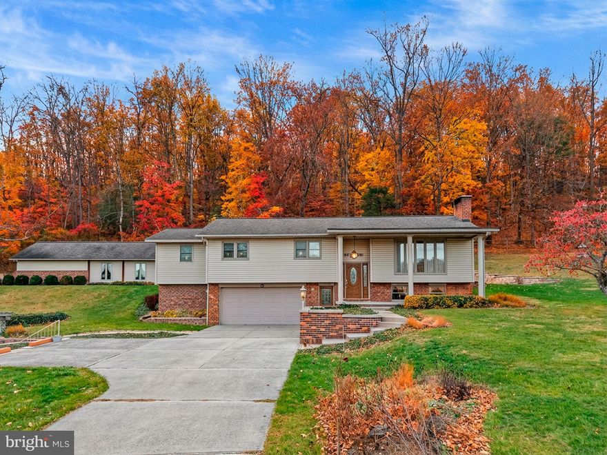 Welcome to this beautifully maintained split-entry vinyl and brick home, perfectly situated on 2.889 scenic acres. Offering exceptional space, comfort, and craftsmanship, the property impresses both inside and out with a thoughtfully designed rear addition, a luxurious primary suite, and numerous quality upgrades throughout.

The main level features a stunning renovated kitchen with ample cabinetry, generous prep space, and all appliances included—ideal for both everyday living and entertaining. Adjacent to the kitchen, the formal living room is highlighted by a sparkling crystal chandelier, illuminated each morning by the sunrise streaming through the large picture window. Spanning the full length of the home, the rear addition is bathed in natural light and offers expansive windows overlooking abundant wildlife and vibrant perennial gardens. An electric fireplace and geothermal floor heating create a warm, inviting retreat in every season. Whole-home surround sound and central air enhance comfort and enjoyment year-round.

The main-level primary suite is a true sanctuary, featuring a spa-inspired bathroom with geothermal heated floors, an oversized jetted tub, and convenient in-suite laundry. Two additional bedrooms, a full bath, and a half bath complete the main level. The finished basement offers a spacious living area centered around a cozy wood stove, along with a kitchenette, half bath, and laundry closet—providing flexible space for relaxation or entertaining.

Outdoor living is equally impressive and designed for year-round enjoyment. A picturesque 75’ x 75’ pond, ranging from 4 to 10 feet deep, features a lighted fountain, wood and stone decking, and excellent fishing opportunities. Overlooking the pond is a pergola with a large stone fireplace, creating the perfect setting for fireside gatherings on cool evenings or peaceful relaxation during warmer months.

Additional highlights include a two-car attached garage with an adjoining encapsulated heated and cooled storage space, a 20’ x 30’ pole barn for larger equipment or storage needs, and a 24’ x 40’ outbuilding offering a workshop, extensive storage, and a root cellar ideal for preserved goods. Beautifully maintained flowerbeds and garden areas enhance the natural beauty of the grounds, while mature fruit trees on the adjacent acreage provide seasonal harvests and contribute to the property’s private, pastoral atmosphere.

Select equipment—including multiple mowers, a Bobcat tractor, a low-boy trailer, and a zero-turn mower—is available for purchase, and all home furnishings are negotiable.

Lovingly cared for and rich with cherished memories, this exceptional property is now ready to welcome its next chapter