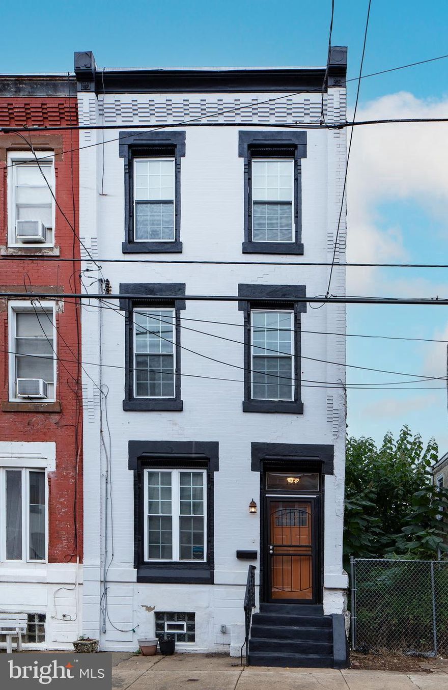 Welcome home to 1750 N. 25th Street, perfectly situated in the booming Brewerytown neighborhood. This fully renovated four bedroom, two-and-a-half-bath home blends classic Philadelphia charm with modern design and is move-in ready for its next owner.
From the moment you arrive, you’ll be drawn to the timeless brick facade accented by an ornate cornice. Step through the breezeway and into the open first floor, where soaring ceilings, hardwood floors, and a stunning exposed brick wall set the tone. The modern open-concept layout flows seamlessly into a beautifully appointed kitchen featuring a breakfast bar, all-new stainless steel appliances, and ample storage. A convenient half bath and pantry are tucked neatly toward the rear of the home.
Out back, enjoy a generously sized fenced yard with western exposure—ideal for summer evenings, entertaining, or relaxing BBQs.
The second floor offers even more character with additional exposed brick, a decorative fireplace mantel, three bedrooms, and a full hall bath. The third floor is dedicated to the spacious primary suite, complete with two closets and a private full bathroom, creating a peaceful retreat.
Located in a growing and thriving community, this home also features a 10-year tax abatement and offers easy access to I-76, Center City, and all that Brewerytown has to offer. Don’t miss this opportunity to own a beautifully renovated home in one of Philadelphia’s most convenient neighborhoods.