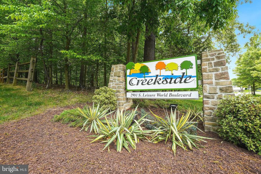 55+ community !! One of Creekside Largest interior space with  the biggest enclosed sunroom overlooking a peaceful setting. Sunroom with walls of windows that brings the natural sunlight with treed view and a perfect place to relax and enjoy your morning coffee or reading  a book. "K " model with 2 bedroom,, 2 full baths and den/library . Fabulous remodeled kitchen with stainless appliances, quarts countertops, tile backsplash, abundance of cabinets, pantry and table space. Entire condo has gleaming floors, 9' ceilings, gas heat, washer/dryer  and garage parking # 64 and a storage cage  room #1 bin #50. Owner's suite has a walk-in closet and additional closet and is very spacious . Second bedrooms spacious too. Living room, bedrooms have access to the sunroom. Creekside has a guest suite you can rent for the night, party room , patio area and library. Come live the Leisure World lifestyle with tons of amenities and clubs to join, 18 hole golf course, tennis ,pickelball, fitness center, restaurants, indoor/outdoor pool, shuttle service and the list goes on....