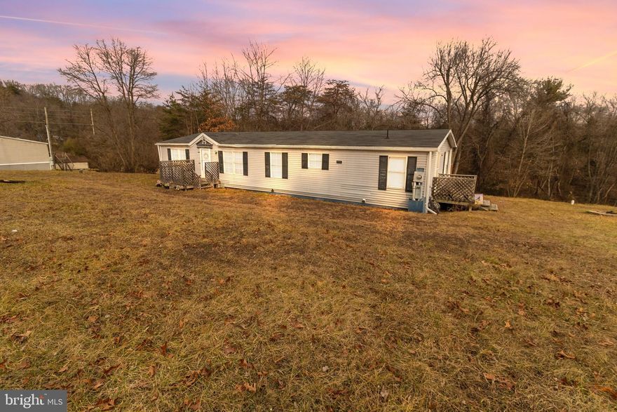 CASH ONLY!!!!!! Priced way BELOW appraised value!!    Walk into your new home with equity.  "As Is' Double-Wide Home on Permanent Foundation – Hedgesville, WV. Nestled on 0.91 acres of serene West Virginia land with NO HOA, this move-in-ready double-wide home offers both comfort and privacy! The property does need some work, but with a little love, TLC, no lot rent, and no HOA, you could own it.  Features include a new deck that's perfect for relaxing or entertaining. The new roof was recently replaced for peace of mind. There is also a New Water Softener, a new Kitchen Floor, new central heating and air conditioning, and a New Outdoor Shed for extra storage of tools and toys.  This property combines modern upgrades with the charm of rural living, offering space to stretch out and enjoy the outdoors. Conveniently located in Hedgesville, it’s close to amenities while still providing the tranquility of country living.  Don’t miss this rare find!