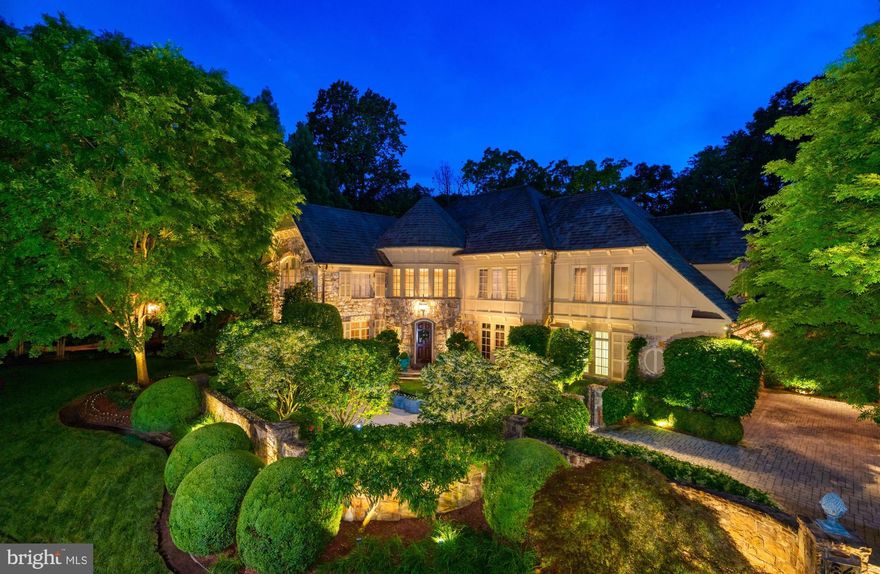 Inspired by the finest traditions of European architecture and design, this world-class residence is beautifully designed both inside and out! The gorgeous Stone and Stucco exterior has custom-designed iron gates and a tumbled limestone front courtyard. As you enter the backyard through a custom door with iron and wood accents you see the rose garden with a pergola overlooking the luxurious pool and a flagstone terrace with fireplace that is ideal for al fresco dining and entertaining. Upon entering the home, you are greeted by the dramatic Grand Foyer with a custom curved staircase crafted with hand-forged iron balusters opening to an elegant Living Room with a fireplace surrounded by an antique mantle and sconces overlooking the front garden. The Dining Room has inlaid hardwood floors and is intimate but open with a wall of windows and antique chandelier. The tranquil Library & Office overlooks the front courtyard has custom bookshelves, built-in cabinetry and embossed leather ceiling. The Kitchen is stunning with custom cabinets and top-of-the-line appliances. The Breakfast Room is surrounded by windows with a custom fireplace that opens to a covered terrace with picturesque views. A splendid two-story Family/Great Room is open to the Kitchen or discreetly closed with mirrored doors. The Family/Great Room is wonderful for entertaining with a magnificent antique marble fireplace from France, gorgeous mantle, floor to ceiling windows and fixed French doors with Juliet balconies that have breathtaking views of the private wooded backyard, stone courtyard and tranquil pool. The Second Level is devoted to the Master Suite complete with a sitting area that has a gas fireplace with custom mantle, completely renovated luxurious Master Bath with marble floors, separate vanities, custom shower and Poliform custom designed Master Closet. There are three additional generous en suite Bedrooms that are each beautifully done all with Poliform closet systems. There is Lutron lighting throughout, 6 Gas Fireplaces and all bathrooms have Sherle Wagner and Waterworks plumbing fixtures and sinks. The walk-out Lower Level does not disappoint with the same level of quality including a Recreation Room, Wine Tasting Room, Theater, Fitness Room, Office, Bedroom and Full Bath. Enjoy private resort-style living minutes from great shopping, dining and hiking trails in the sought after Woodlea Mill neighborhood!