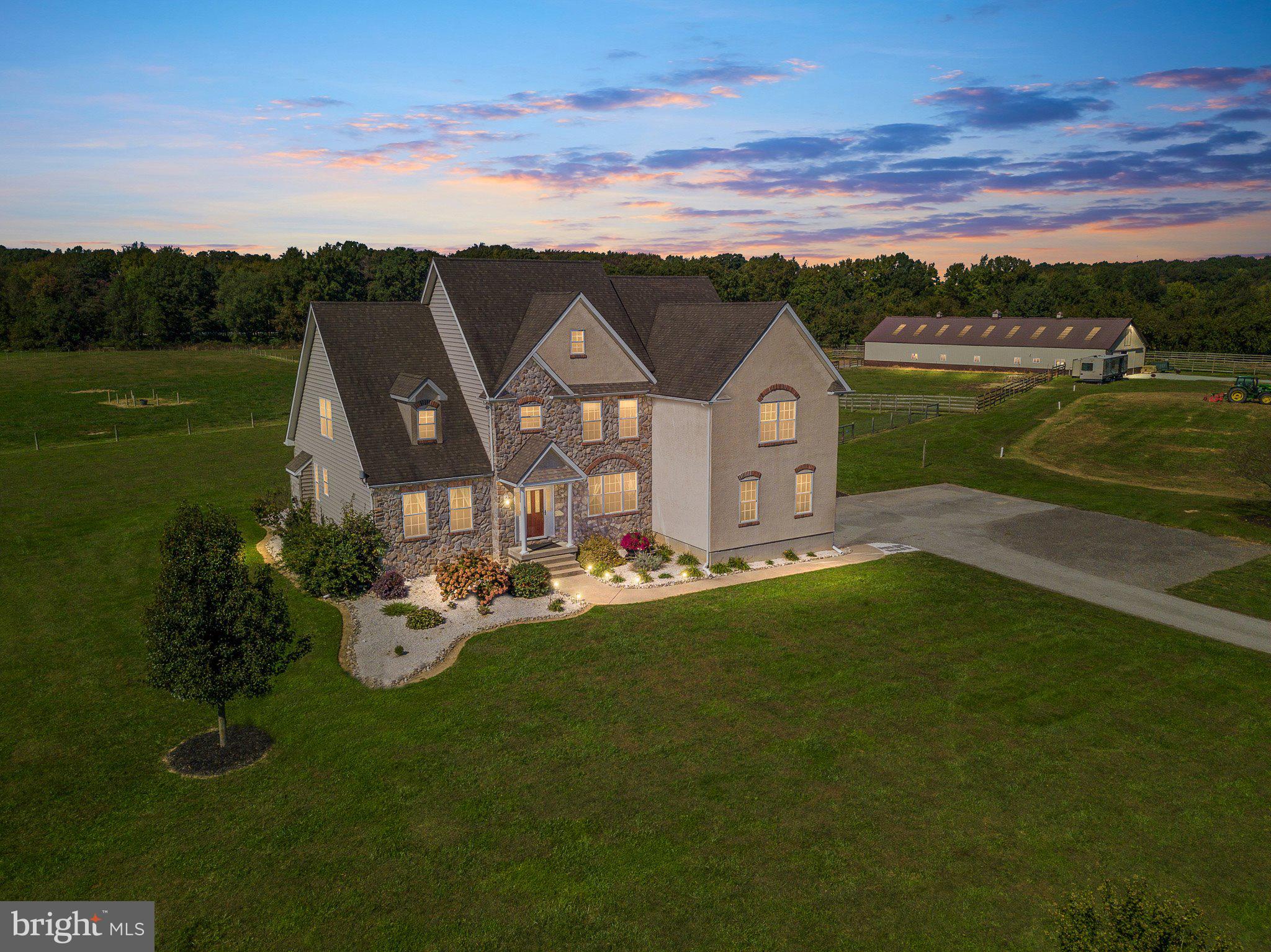 Nestled in the serene landscapes of Warwick, MD, just a stone's throw away from Middletown, DE, lies this stunning custom-built (2008) home on a vast 17+ acre lot. Luxurious upgrades, this property is the epitome of elegance and comfort. The residence features 4 generously sized bedrooms, 3.1 baths, and a main level bedroom suite complemented by a cozy fireplace. The gourmet kitchen is a chef's dream, while the cathedral ceilings adorned with exquisite moldings elevate the home's grandeur. The property is equipped with 2 heat pumps, one of which is brand new as of 2023, and 2 on-demand hot water heaters. The expansive deck offers the perfect setting for hosting and entertaining.
Equestrian enthusiasts will be captivated by the custom built center aisle barn with 14 generous size box stalls with 60" fans in every other stall, large tack room, bathroom, W/D and an office. The barn also features a spacious loft, Several run-in sheds.
The potential for this estate is boundless. It's a potential income-producing property waiting to be tapped into, with two separate electric meters, one for the home and another for the barn. The on-site RV hook-up is complete with septic and water facilities. And for those who cherish the outdoors, the property's proximity to Bohemia Creek Park, St. Augustine PC, Mt. Harmon, and Fox Hunting, Delaware Park, Fair Hill Equestrian Center locales are unparalleled. Breeders will also find value in the nearby Maryland Stallion Station, Select Breeder Services, and Winback Farms. All this located in the heart of Warwick MD!