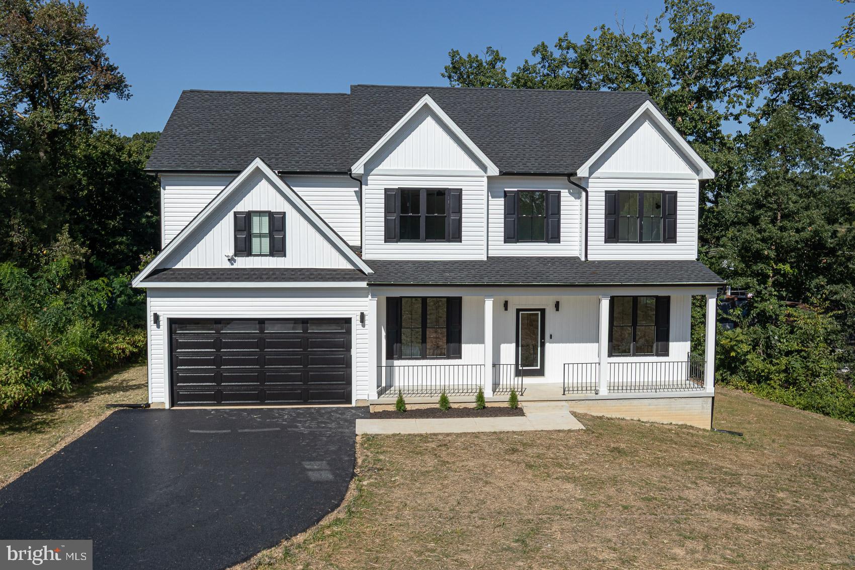 Welcome to an extraordinary modern farmhouse masterpiece in the heart of Carney (21234). This brand-new construction offers 5 spacious bedrooms and 4 full baths, including a luxurious owner’s suite with sitting area and fireplace, a large junior suite, and a welcoming first-floor bedroom suite that’s perfect for guests or multigenerational living. Blending elegance with innovation, the home features custom black windows that create striking curb appeal and flood the interiors with natural light. Inside, you’ll find smart home technology including a video doorbell, Bluetooth ceiling speakers on multiple levels, and exterior cameras on all sides for ultimate peace of mind. The main level impresses with wood flooring, dramatic accent walls, coffered ceilings, and a custom tile fireplace. A custom wine wall serves as a one-of-a-kind centerpiece for entertaining in style. The gourmet chef’s kitchen boasts a 10-foot quartz island, 42” shaker cabinetry, designer backsplash, and premium stainless steel appliances. Upstairs, retreat to spacious bedrooms, a convenient laundry room, and a show-stopping primary suite with a multi-person rainfall shower, oversized soaking tub, and dual vanities in a spa-inspired bath. Designer lighting, luxe tilework, and upgraded fixtures elevate every detail throughout the home. Outside, enjoy a two-car garage, oversized 6+ car driveway, and expansive lot—ideal for entertaining and gatherings. Perfectly situated near major highways, shopping, and top universities, this home combines modern sophistication, timeless style, and everyday comfort.