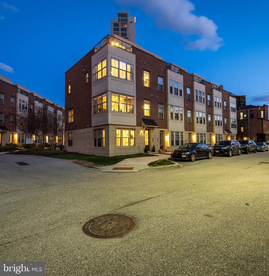 This fabulous end unit in Keys Overlook offers the best of urban living with high ceilings and abundant natural light. There is plenty of parking with an attached 2 car garage .The views are unbelievable with the quintessential roof deck with impressive panoramic views of the Inner Harbor and city skyline. The second floor features a desirable open floor plan with a dining area, a gourmet kitchen with stainless appliances, a fabulous center island and family room with a cozy gas fireplace.  Upper levels offer convenient laundry and well-proportioned bedrooms including a primary suite with walk in closet and luxe bath. The top level is prepped to host your summer roof soirées- just stock the beverage fridge in the wet bar with your favorites and you’re ready to relax with a bird’s eye view of it all!