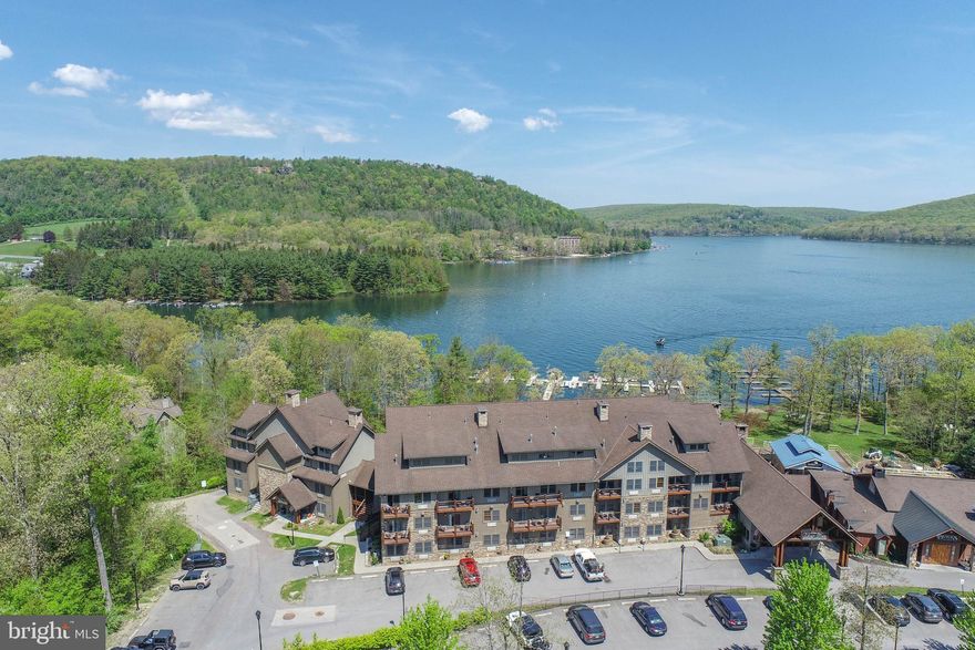 Waterfront condo at Silver Tree Suites on Deep Creek Lake! This furnished 1 bedroom, 1 full bath loft unit offers 785 square feet across two levels and is one of only four layouts in the building with a private bedroom. Featuring granite countertops, a granite hearth, gas fireplace, fresh paint, updated furniture, carpet, and luxury vinyl plank flooring. The kitchenette includes a dishwasher, microwave, and refrigerator. Wall unit heat and A/C, public water and sewer, and shared laundry keep ownership simple. Elevator building with exercise room, sauna, extra storage, common grounds, and lake privileges with fishing and canoe/kayak access. A clean, low-maintenance lakefront opportunity in a well-known waterfront community. Call today for details!