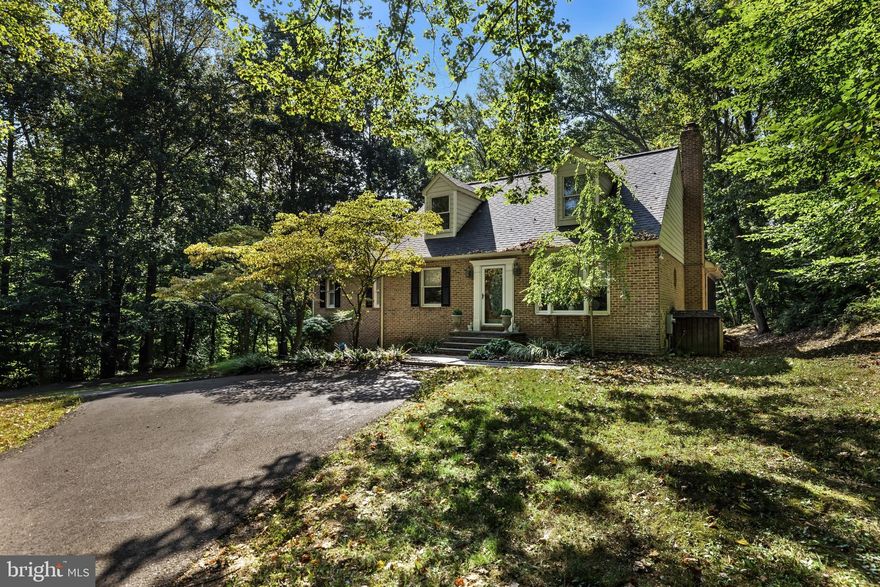 Price reduction on this charming cape cod which offers three bedrooms and two full baths in a serene  private setting.  Inside, the home has generous living spaces with an open floor for todays living. First floor includes a large living room with crown molding, spacious dining room, kitchen with breakfast bar opens to family room with beautiful stone wood burning fireplace.  The kitchen and family room have access to the large screened in porch. Large  first floor primary suite with cathedral ceiling, double closets and full bath with soaking tub and walk in shower.   The upper level has two additional nice sized bedrooms and a full bath with walk in shower,  and plenty of closet space.  The lower lever has space for a finished club room or play room along with a utility room with the washer and dryer.   Attached garage is also on the lower level.  The large screened in porch offers additional living space for the spring, summer and fall and backs to woods for a lovely oasis.  Freshly painted interior, whole house generator,  newer roof with a 50 year warranty.