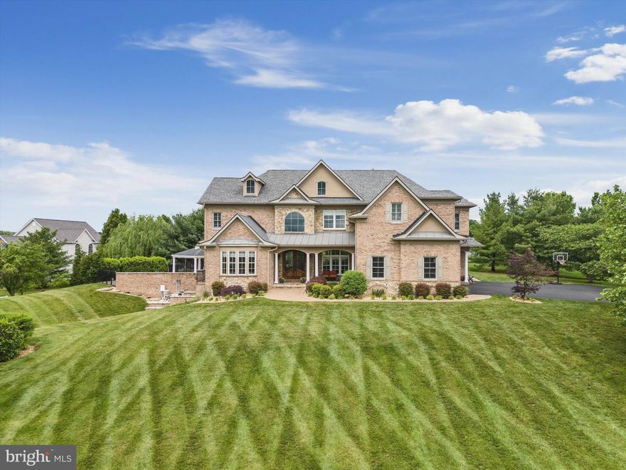 This beautifully conceived Colonial is a veritable resort unto itself, loaded with amenities from the marble floored entry with grand staircase, through the two story great room  and into the family room open to the gourmet kitchen with two islands. Huge Media, Game and exercise rooms compete with the outdoor entertainment area with its own kitchen, massive pool and Fire Pit and incomparable views. A main floor in-law suite features a wheelchair accessible bathroom with double sinks.  Unique features include special rubber flooring and high impact drywall in room set up for indoor volleyball or working-out,  Media Room comes with sound proofing and hardwired subwoofer sound system.  Storage closets in lower level include one outfitted for storage of skis and snowboards.  Home has extended range, multiple point wifi access including pool area. Outdoor shower for pool area.  There is also a Sonos indoor/outdoor sound system.