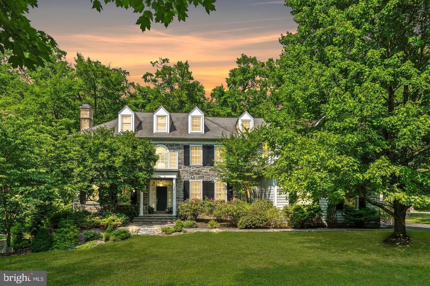Tucked away in the prestigious community of Villanova, within the highly regarded Radnor Township, this exceptional five bedroom residence embodies refined living at its finest. Set on a beautifully landscaped 1.5 acre lot, the home is surrounded by mature trees and bordered by a tranquil creek, creating a private and picturesque setting that feels worlds away yet remains moments from everything.

A long, stately driveway leads to a three car garage and generous parking area, providing both elegance and convenience. The location offers easy access to major thoroughfares, award winning schools, and an array of upscale shopping, dining, and recreational destinations.

Upon entering, you are greeted by an atmosphere of timeless sophistication. Gleaming hardwood floors flow throughout the main level, enhancing the light filled spaces. The formal living and dining rooms, each graced with a classic fireplace, exude warmth and charm, perfect for entertaining or relaxing in comfort.

The gourmet kitchen is the heart of the home, featuring custom cabinetry, high end appliances, and a sunlit breakfast room that opens to an expansive deck overlooking the peaceful grounds. Adjacent to the kitchen, the inviting family room offers a comfortable space for everyday living. A private first floor office provides an ideal setting for work or quiet study.

The fully finished walk out lower level extends the home’s living space, offering a striking ambience that is both modern and inviting. Featuring a large entertainment area and a full service bar, it is the perfect setting for hosting gatherings or enjoying relaxed evenings with family and friends.

Upstairs, the second level offers five spacious bedrooms designed for comfort and privacy. The primary suite serves as a luxurious retreat, complete with generous closets and a beautifully appointed bathroom. Each additional bedroom offers ample storage and access to well designed baths.

The finished third floor adds valuable flexibility, currently configured as a gym and laundry area but easily adaptable as a media room, playroom, or additional living space.

Blending classic architecture with modern amenities, this Villanova residence delivers a lifestyle of sophistication, comfort, and tranquility, all within one of Radnor’s most sought after neighborhoods.