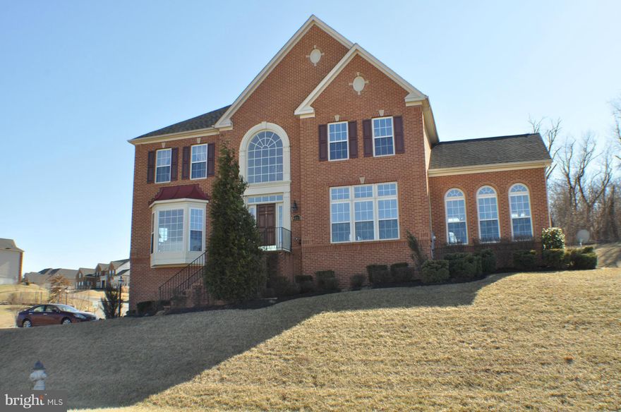 This beautifully appointed home has it all. Gleaming hardwood floors, gourmet kitchen w/ ceramic tile floors, island, granite counters, cherry cabinets, stainless steel appliances, ceramic tile baths, media room in finished basement - big family room w/ vaulted ceilings, main level bedroom/full bath, living room & dining room w/ columns,  2 story entry w/ grand staircase - on almost 3/4 Acre