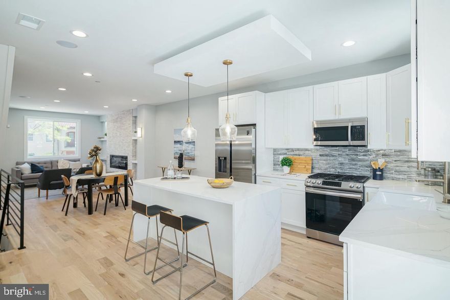 Stunning new construction 4-bedroom, 4 full-bath home located in the rapidly growing West Kensington / Norris Square Park neighborhood, just minutes from Fishtown and Northern Liberties. Situated on an expansive 19’ x 50’ lot, this thoughtfully designed residence offers a rare layout with a private full bathroom for every bedroom. Featuring modern, high-end finishes throughout, the home includes hardwood flooring, recessed lighting, central air, built-in Bluetooth surround sound, a video intercom and surveillance system, fireplace, wet bar, and a spacious fiberglass roof deck with panoramic 360-degree views. The gourmet kitchen is outfitted with waterfall quartz countertops, custom cabinetry, a tiled backsplash, and a full stainless steel appliance package including refrigerator, gas range/oven, microwave, dishwasher, and garbage disposal. Just off the kitchen, enjoy a private rear patio enclosed by a privacy fence—perfect for outdoor entertaining. The fully finished basement offers a large bedroom with a window light well and a full bathroom featuring a glass-enclosed shower. The second level includes two generously sized bedrooms with ample closet space, two full bathrooms, and a conveniently located full-size front-loading washer and dryer. The third floor is dedicated to a luxurious primary suite, complete with a wet bar, spa-like bathroom, walk-in closets, and a tray ceiling with ambient lighting. Ideally located within walking distance to the York–Dauphin Station and close to Fishtown and Old Kensington’s dining, nightlife, and entertainment, with easy access to I-95. The property also includes the remaining years of a 6-year tax abatement.