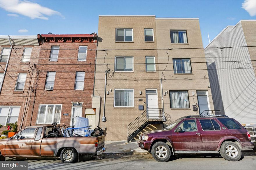 Stunning new construction 4-bedroom, 4 full-bath home located in the rapidly growing West Kensington / Norris Square Park neighborhood, just minutes from Fishtown and Northern Liberties. Situated on an expansive 19’ x 50’ lot, this thoughtfully designed residence offers a rare layout with a private full bathroom for every bedroom. Featuring modern, high-end finishes throughout, the home includes hardwood flooring, recessed lighting, central air, built-in Bluetooth surround sound, a video intercom and surveillance system, fireplace, wet bar, and a spacious fiberglass roof deck with panoramic 360-degree views. The gourmet kitchen is outfitted with waterfall quartz countertops, custom cabinetry, a tiled backsplash, and a full stainless steel appliance package including refrigerator, gas range/oven, microwave, dishwasher, and garbage disposal. Just off the kitchen, enjoy a private rear patio enclosed by a privacy fence—perfect for outdoor entertaining. The fully finished basement offers a large bedroom with a window light well and a full bathroom featuring a glass-enclosed shower. The second level includes two generously sized bedrooms with ample closet space, two full bathrooms, and a conveniently located full-size front-loading washer and dryer. The third floor is dedicated to a luxurious primary suite, complete with a wet bar, spa-like bathroom, walk-in closets, and a tray ceiling with ambient lighting. Ideally located within walking distance to the York–Dauphin Station and close to Fishtown and Old Kensington’s dining, nightlife, and entertainment, with easy access to I-95. The property also includes the remaining years of a 6-year tax abatement.