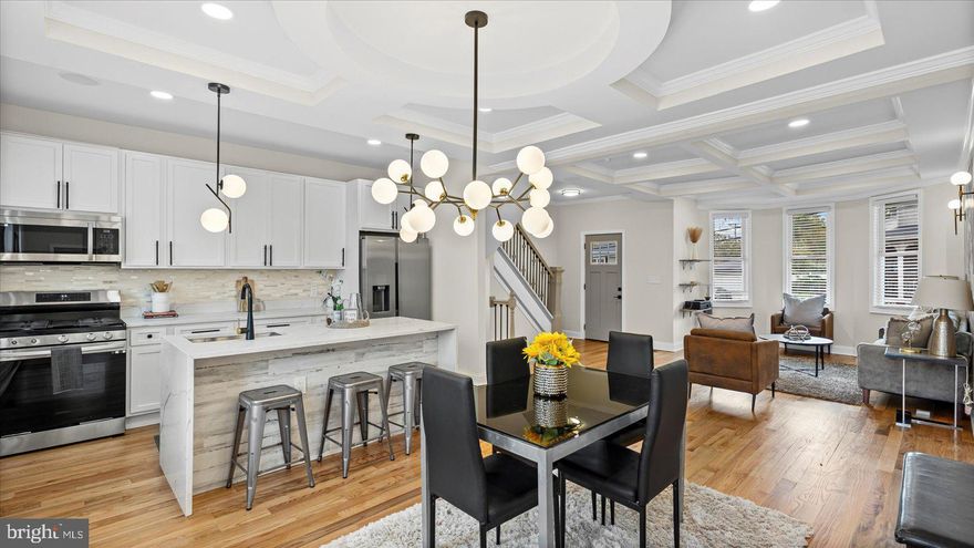 You're just in time for the holidays! This spectacular 6-bedroom, 6.5-bath residence perfectly blends timeless charm with modern sophistication. The open-concept main level features elegant hardwood floors, a striking living room feature wall, tray ceilings, a stylish half bath, and a dining area ideal for entertaining. The gourmet kitchen is a chef’s dream, boasting stainless steel appliances, 42-inch cabinetry, and luxurious Calacatta quartz countertops with a waterfall island. Just off the living room, you’ll find a spacious en-suite bedroom for added convenience. Upstairs, the second level offers two en-suite bedrooms (one with a private walkout deck), an additional bedroom, and a flexible den or office space. The top level is bathed in natural light and includes a walk-in closet, full bath, and extra storage. The fully finished lower level adds even more living space with another bedroom and full bath. Outside, enjoy a roomy side and rear deck, a generous backyard, and a detached garage. No need to procrastinate with this beauty.  Schedule your tour today and fall in love with your new home!