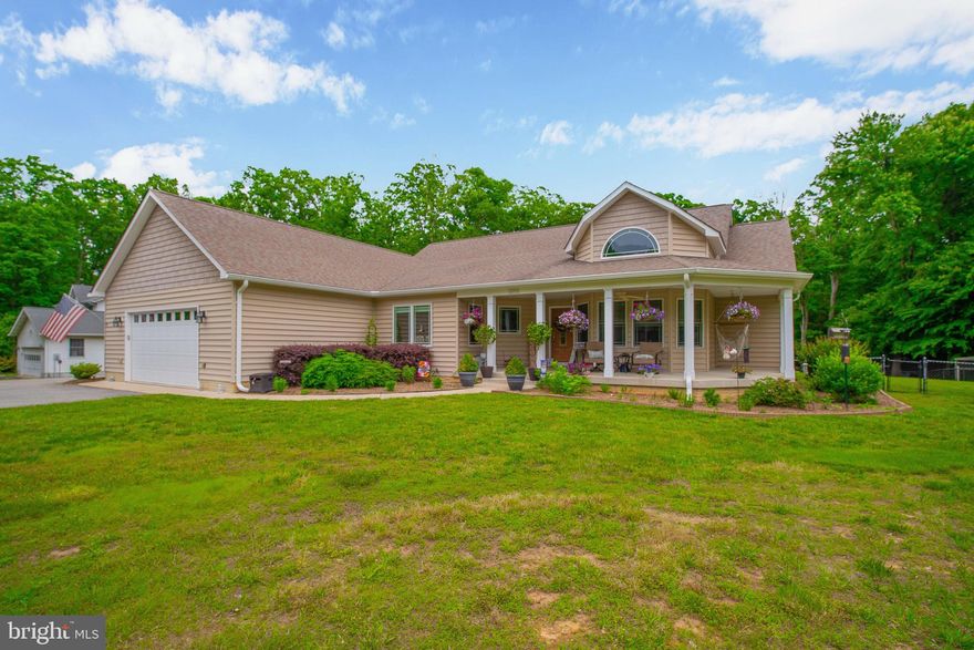 Come sit on the front porch and relax a while! Don’t miss this charming custom-built craftsman style home on nearly 5 acres. Freshly painted, the home has 4 bedrooms and 3 full baths with bamboo and new LVT flooring.  Get cozy by the double-sided fireplace between the enormous living room and sunroom.  If you love to cook the kitchen is for you! Granite countertops, prep-sink, 6-burner propane cooktop with a pot filler and a huge walk-in pantry make this a family hangout! Retreat after a long day to your 400 sq. ft. master bedroom with ensuite bathroom including soaking tub.  You’ll find plenty of storage in the walk-in closet with built-in dressers. Doing laundry is a breeze with the installed laundry chute and large countertop for folding. The basement is an entertainer’s dream with a custom-built bar including a beer tap. Storage is not a problem with 4 oversized storage rooms in the basement along with extra storge in the garage attic.  The climate controlled over-sized garage has plenty of room for all your “toys” with a separate side entrance to the extra parking pad. Enjoy the patio with an outdoor kitchen while kids and pets play in the huge, fenced backyard. Seller is offering $5000 in closing help.