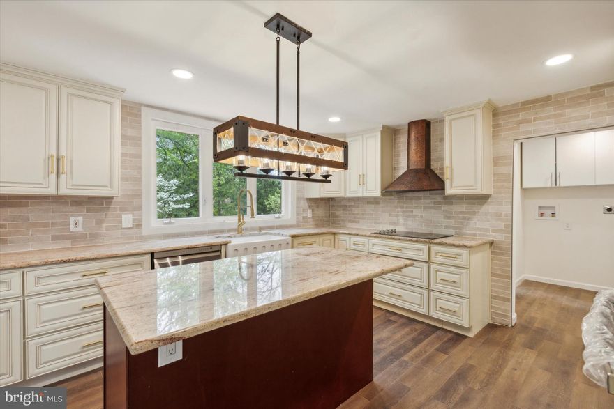 Stunning Renovation!  This home was built as a blacksmith shop, with a wheelwright's addition and is a historical treasure.  The home has  undergone a major transformation!  Enter the front door,  into a keeping room, then through to the living room with the original beamed ceilings and immense fireplace.  Then you can go through a beautiful barn door to the spectacular newly renovated antique white kitchen with granite counter tops, center island with storage, farmhouse style sink, new cooktop, new stainless appliances and subway tile backsplash  This kitchen is a show stopper and has picture window above the kitchen sink with beautiful views of the meticulously manicured rear lawn  There is a door to the newly installed deck which spans the entire width of the home.   From there, you go through to the mudroom and updated powder room.  Then through to the oversized family and dining room.  The family room also has huge deep fireplace and original beams.  The primary bedroom is an addition from 2001, but has been  completely updates with primary ensuite bath, with double vanity, freestanding soaking tub and fabulous tiled shower  The  bedroom has lots of windows and beamed tall ceilings and a walk-in closet with barn door entry.   Did I mention that the primary suite has doors out to the deck. as well as there is a ramp from the rear parking area that makes the first floor readily accessible?  Going up the original staircase, you will find three addition ample sized rooms and gorgeously appointed full bath with double vanity.  The home has a new rear portion of roof, new siding, stucco in rear re-done, new deck, new HVAC, new plumbing, new electrical, new flooring throughout the home, new lighting, new front door and some new windows.  A stream and established trees border the property, giving the new home owner a fabulous oasis for family get togethers or other  entertaining.  The thick stone walls keep the home cool in the summer and warm in the winter  Minutes from  vibrant Malvern borough and the train station and across from the  historic General Warren Inn, the home provides easy access to shopping (Wegmans, Target and the cute shops and restaurants in Malvern, such as the The Buttery,  The Flying Pig and Brick and Brew). Rt. 30 and Rt 202 are super close by.  The home is located in award winning Great Valley School District.  YOU really want to come see this home with all of the renovations that make it comparable to new construction, but with the charm and historical significance of a this 18th  Century home!