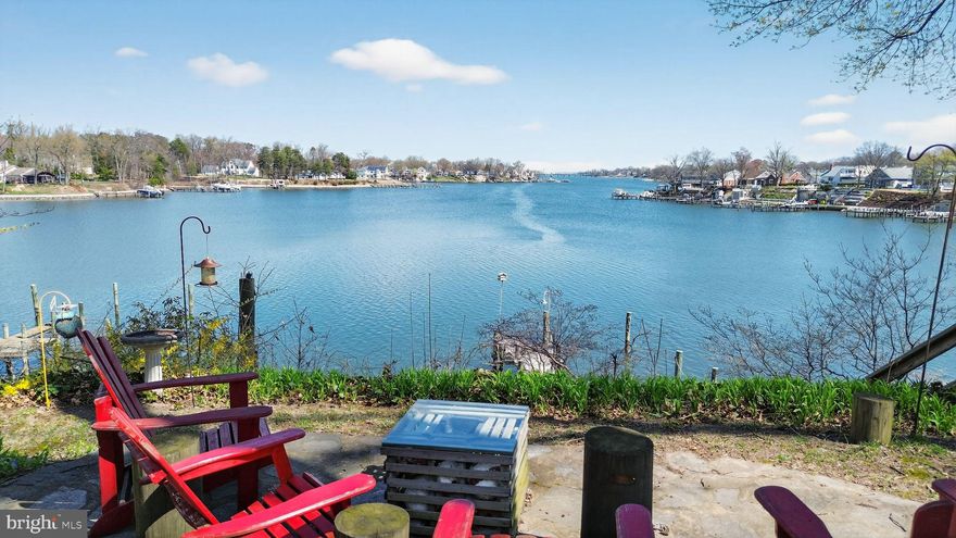 Exceptional waterfront retreat offering breathtaking, panoramic views across Stoney Creek and out to the scenic Patapsco River. **Price Reduced $35,000** Perfectly positioned to capture endless water vistas, this home delivers a private, peaceful setting with direct access to some of the area's most desirable boating waters on an oversized double lot.
Enjoy true waterfront living with your own private dock, complete with power and water, deep water access ideal for both sail and power boats, and a protected shoreline with bulkhead. From the patio take the wooden steps down to a flat, usable waterfront space at dock level—perfect for relaxing, entertaining, crabbing, fishing, and launching your paddleboard or kayak.
The home itself is filled with character and natural light, featuring a dramatic great room with exposed beam vaulted ceilings, a striking stone fireplace, and walls of glass along the waterside that frame the stunning views. The open floor plan is filled with natural light. Enjoy the waterfront screen porch and a flagstone patio, creating seamless indoor-outdoor living. 
Additional highlights include a recently updated roof, low-maintenance vinyl siding, and an attached two-car garage with rare private-entry suite above the garage—offering a third bedroom and second full bath, ideal for guests or extended family. The partially finished lower level with direct access includes a recreation room, half bath, and laundry area.
Set on an oversized, incredibly private lot, the property also features a recently installed concrete driveway with parking for six or more vehicles. Nature lovers will appreciate the abundant wildlife and serene backdrop provided by the nearby Stoney Creek Park, preserving over 150 acres of protected woodland just across the water.
For added enjoyment, an optional community membership offers access to a nearby boat ramp, pier, and picnic area just a few doors away.
This is a rare chance to own a truly special waterfront home combining privacy, natural beauty, and exceptional access to the water—all within close proximity to major routes, Annapolis, Baltimore, and Washington, D.C.