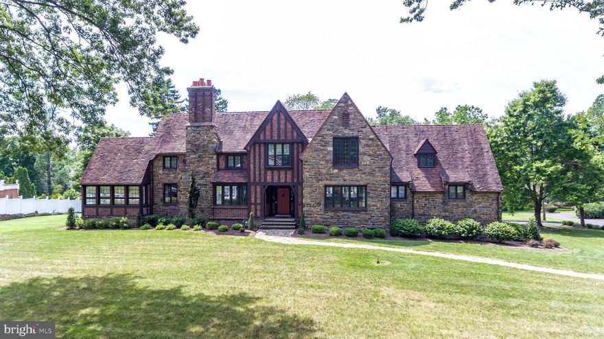 Old world style, and remarkable elaborate architectural character exudes this authentic 1928 Tudor style home. This majestic property is a cornerstone for the desirable estate neighborhood of Delavue Manor in Yardley.  Meticulously and stunningly updated within the past 3 years while still offering the finest of original features from its era including, solid  quarry stone & brick work, custom Ludowici tile roof with copper flashing, ornate brick and stone chimney with decorative custom clay pots, half timbers and stucco dormers, and embellished front doorway.The interior of this home features a gracious open entry leading to the grand formal living room with 8'6" beamed ceiling, wood burning fireplace. Beyond the living room is a bright and relaxing sunroom with three walls of casement windows offering beautiful views of the surrounding neighborhood properties. Beyond the foyer entry is the expansive dining room featuring a Renaissance influence custom archway to the outstandingly gorgeous pristine white on white designer kitchen with exposed original stone wall, radiant heat, Namibia white marble throughout, white textured subway tile back splash, large farmhouse, floating reclaimed wood shelves, stainless steel Jenn Air appliances, 6 burner range w griddle w pot filler, double oven, under counter drawer microwave, wine refrigerator, commercial grade hood and exhaust system, and real brick tile flooring. A butler pantry features travertine marble floors, porcelain farmhouse sink, leathered black granite counter-top, 2 additional beverage refrigerators, Electrolux washer/dryer. A guest quarters is conveniently located beyond the butler pantry and offers a updated full bath with marble basket weave Carrera tile floor, hexagon marble tile shower floors, super white quartzite vanity, and marble subway tile wall. Also on the main floor is a powder room featuring distinct original believed to be green Fulper tile.Follow the original Tudor carved winding oak stairway adorned with a beautiful antique gothic church light fixture to the upper level of this home offering a main bedroom featuring 9 5 ceilings, generous walk-in closet, casement windows over looking the backyard. A luxurious updated main bath, offers Calcutta gold marble tiles, Taj Mahal granite, custom walnut vanity, satin brass California and Jaclo satin brass fixtures, Lava Stone tub, a Rejuvenation lighting, and  radiant heat floors. A sitting room provides more than ample space to sit back and relax before retiring for the evening. Also on this level are two en suites featuring updated custom features, designer tile and fixtures. The lower level of this home features luxury laminate gray wood tone flooring, wood burning stone  fireplace. This level offers a fabulous area for entertaining guests or private retreat area. Additional storage area, utility area and access to the driveway and garage are on this level. Other fine features of this home include: updated plumbing, updated electrical, mission/gothic lighting throughout the home, 8'6" ceiling height main floor, 9'5" ceiling height upper level, all fixtures used in the house are DXV, California faucets and Jaclo, refinished original solid oak hardwood floors main and upper level, newer 2 zone heating and AC throughout the home including the basement, newer water main and sewer line,  professionally landscaped and hardscaped. Close to downtown Yardley Boro, within minutes to New Hope and Princeton. Easy access to 295 (I95), NJTransit, Septa, 40 minute commute to Philadelphia and just over an hour to NYC via NJTransit. Enjoy biking on Delaware Canal path, many Bucks County Parks close by, museums and Bucks County Playhouse just minutes away.  Fabulous famous chef restaurants and so much more.