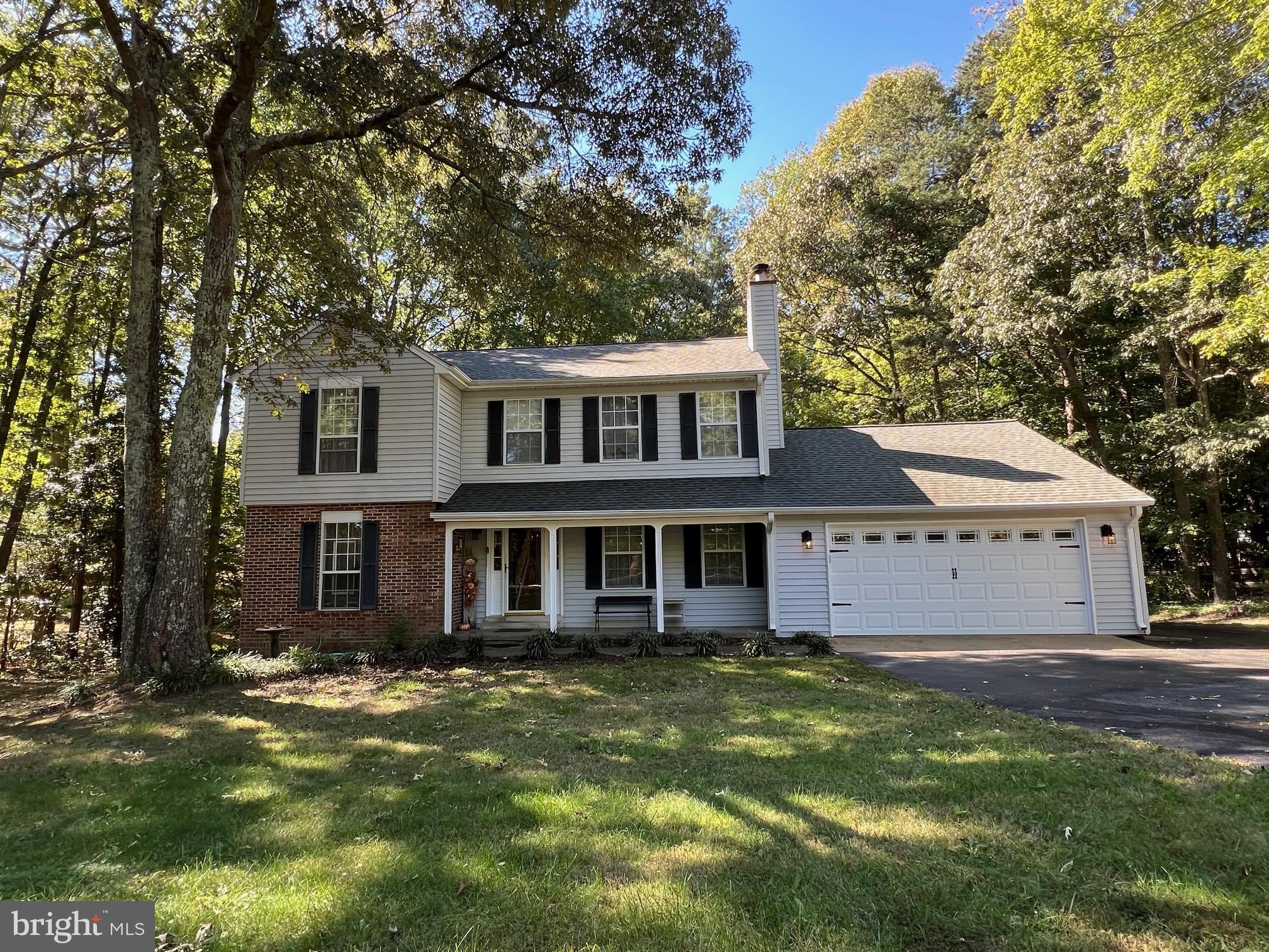 This well-maintained two-story colonial is nestled on a serene wooded lot. The kitchen, remodeled less than 10 years ago, features stunning quartz countertops, a tiled backsplash, a farmhouse sink, Vinyl plank flooring and an island. The family room includes a cozy fireplace, while the dining and living rooms boast beautiful hardwood floors. Upstairs, you'll find three spacious bedrooms and two full baths. The roof is approximately 13 years old, and the heat pump was replaced in 2018. The two-car garage includes pull-down stairs for additional storage. Outside, enjoy the private backyard and deck, perfect for grilling or relaxing. Conveniently located near a water park, sports fields, and Solomons Island for dining and water activities. Plus, no HOA!
