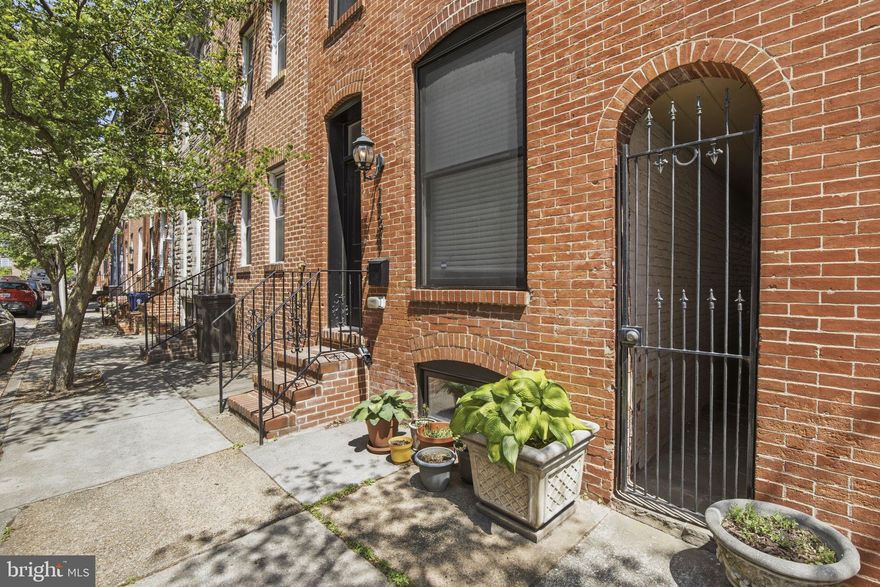 Welcome to 1131 William Street, a stunning custom-built rowhome in the heart of Federal Hill. This historic 14-foot wide rowhome was fully renovated in 2016 and features 5 spacious bedrooms and 4 full bathrooms, an attached garage, and a breathtaking rooftop deck offering panoramic views of the Baltimore skyline and the iconic Inner Harbor.

As you enter, you'll be greeted by the warmth of hardwood floors and the sophisticated touch of custom finishes throughout the open-concept living space. The gourmet chef's kitchen is a culinary delight, featuring high-end appliances, sleek cabinetry, and an eat-in area perfect for casual dining and entertaining. Conveniently located off the main level is access to your private attached garage and shared outdoor stone paved patio.

As you head upstairs, you'll find two generous bedrooms and two full bathrooms, including a primary suite of your dreams. This sanctuary boasts soaring ceilings, a walk-in closet, a spa-like ensuite bathroom, and a gas fireplace. On the third floor, you will find two additional bedrooms, one with a private deck, plus a wet bar that leads directly out to the hallway accessed rooftop deck. The fully finished lower level offers even more flexibility with an additional bedroom and full bathroom.

Don't miss your chance to see this gorgeous, modern Baltimore rowhome in one of the city's most historic and sought-after neighborhoods!