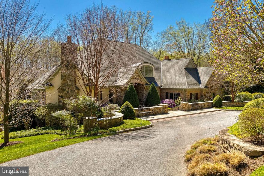 Exceptional Properties. Exceptional Clients. This stunning, custom 5 bedroom, 5.5 bathroom French Country home is tucked off a private, gated lane on 4.6 acres with picturesque views that can be enjoyed from the expansive, multi-level bluestone patio with stone fireplace and hot tub. An entertainer’s dream, this house offers over 7000 square feet of luxurious living space with an abundance of natural light, impressive millwork and ideal floor plan. The main level includes a grand, two-story foyer, handsome study, gracious primary suite (with sitting room, spa-like bathroom and huge walk-in closet with island), dining room, bright and airy gourmet eat-in kitchen, living room (with coffered ceilings and gas fireplace), four season room, powder room and mud/laundry room. The second level features three large bedroom suites - all with their own bathroom and walk in closets. The lower level impresses with an additional bedroom, full bathroom, fitness room (that could easily be used as a 6th bedroom), family room with gas fireplace, impressive bar, temperature controlled wine cellar, theatre room, game room, several large storage closets and multiple doors that lead to the backyard of your dreams. So many warm, sophisticated finishes to note including coffered and tray ceilings, balcony off the kitchen, heated floors on main level, stone accents, high ceilings and more. The 3-car garage, circular driveway, and parking pad provide more than enough space for guests. Enjoy the scenery and quiet of the woods and stream while also being conveniently located just 4 minutes from grocery stores, restaurants, shopping and schools. This gorgeous property is not to be missed!