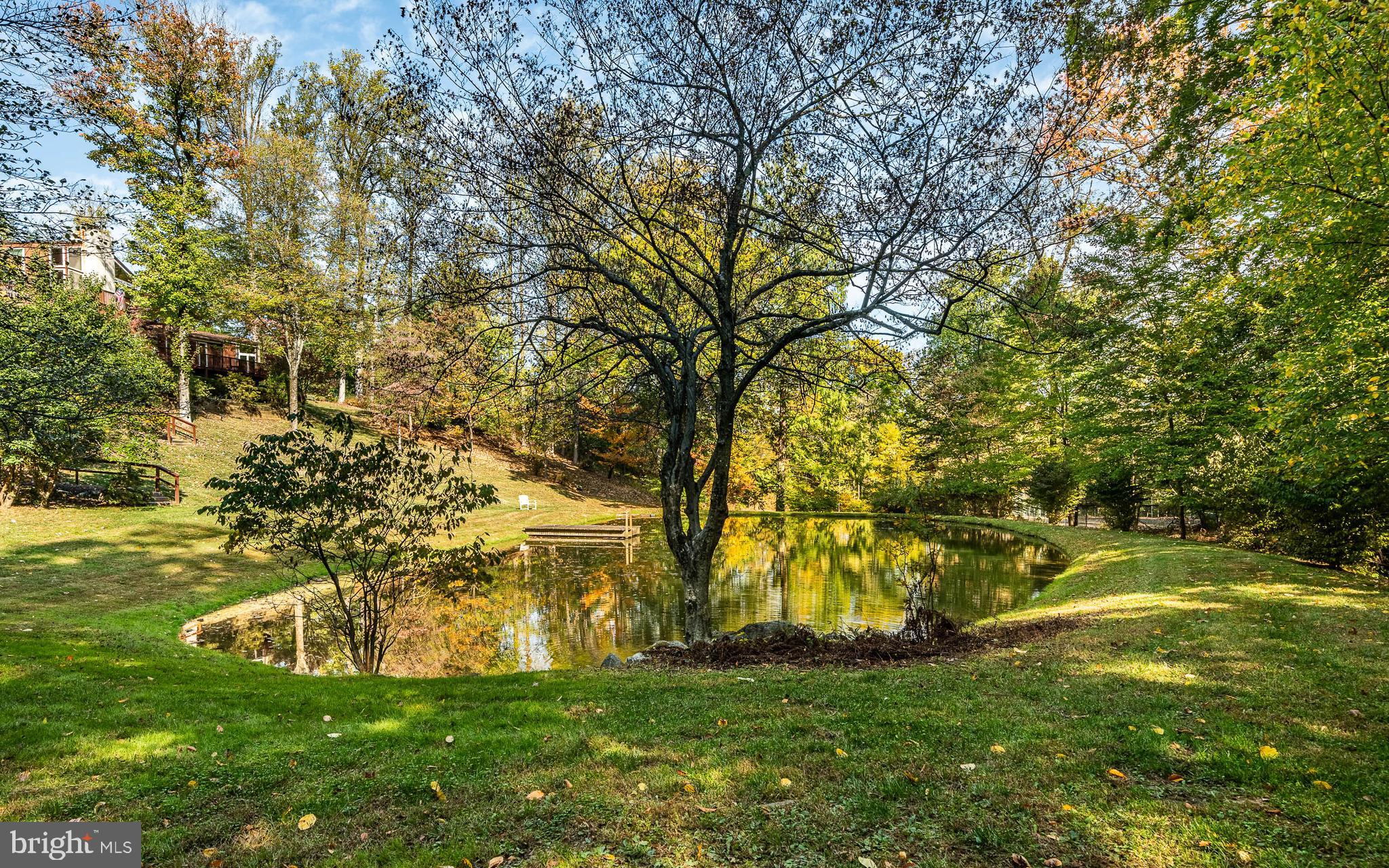 Discover a unique, single-owner custom-built residence nestled within a picturesque 4.6-acre park-like setting in Charlestown Township. This home boasts five bedrooms and four baths, exuding charm from the moment you enter the property. Expansive rooms unfold on multiple levels, framed by architectural windows and Anderson sliders that reveal breathtaking views and provide access to the extensive decks running along the back of the house. Overlooking well-kept lawns and gardens, the property features not one, but two ponds, along with a regulation-sized fenced tennis court. The approach via a curved driveway leads to an upper deck landing with awnings adjacent to the kitchen. Entering through the bespoke front doors, you're welcomed by a spacious foyer with a coat closet and access to all house levels. Descending the steps, a powder room is tucked into a rounded hallway with a skylight. The eat-in kitchen, bathed in natural light from sliders and abundant windows, centers around an island beneath two skylights. Modern cabinets, a flat-top stove with a double wall oven, dishwasher, desk, pantry, dual sinks, and ample storage define this kitchen. Most rear-facing rooms, including the kitchen, open onto the inviting multi-level decks. Inside, the dining room and elevated main living room feature high, wood-covered pitched ceilings, a fireplace, numerous windows, and deck access. Downstairs, the first family room offers another fireplace, built-ins, and a slider to the front of the house. The master suite, with large closets, sliding doors to the deck, and an en-suite bath, begins a long hallway that includes four additional bedrooms two baths and a sitting area and more great windows with access to the far end of the deck. Wait, there's more! This level features the laundry and mechanical rooms, complete with a doorway leading to the secluded lower rec room. It also provides access to the rear decks and backyard of the home. Don't miss out—schedule your appointment today to see this unique retreat set on stunning acreage within the Great Valley School District. Enjoy convenient outings for all your essentials and the lively nightlife and dining scene in Downtown Phoenixville, Malvern, and Valley Forge National Park. With ample shopping and easy access to major thoroughfares, including the Turnpike, it's ideally situated.