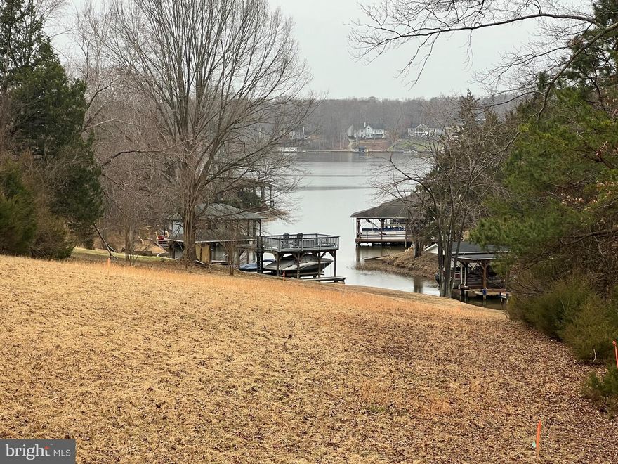 Shared waterfront lot with a slip in the sought-after neighborhood of Rose Valley. Gently sloping and mostly cleared, the lot offers a prime building location. Boat slip # 6 conveys with the property. Located mid-lake, there is easy access by boat to the lake's many restaurants: The Cove, Tims, and the Tap House. It's also a short drive to the off-lake amenities, Food Lion, DG Fresh, Local Wineries, and Breweries. A great opportunity to have waterfront living at an affordable price.