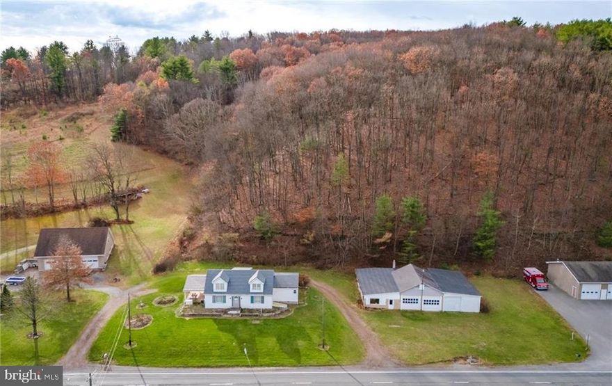 Discover incredible opportunity with this well built and generously sized 5 bedroom, 2 full bathroom Cape Cod set on a 1.8 acre parcel zoned Highway Commercial.  Offering both residential comfort and exceptional business potential, this property opens the door to a wide range of uses - live where you work, operate your business on site or explore income producing possibilities.  Solid construction and a functional layout provide the perfect foundation for your finishing touches.  This Home offers a large eat in kitchen, 3 main floor bedrooms and 2 additional bedrooms upstairs - 2 full bathrooms - ideal for family living, guests or flexible use space.  Outdoors offer a massive 12 car detached garage/workshop stands ready for hobbyists, car enthusiasts, contractors, Entrepreneur or anyone needing serious storage or workspace.  Bring your vision and make this property shine!  Call today for your private showing!