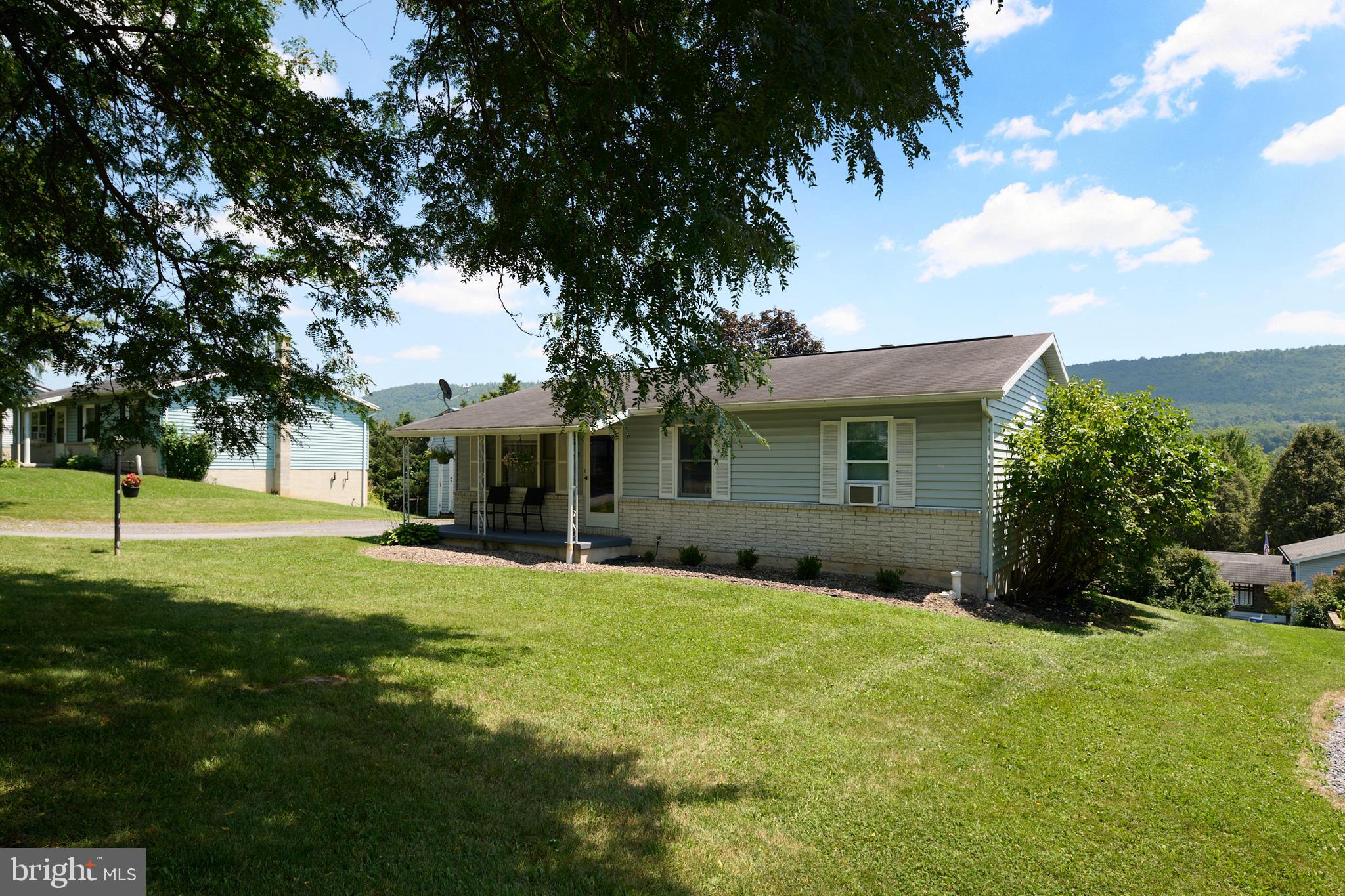 Check out this beautiful and recently updated ranch home with wonderful views of the mountains! This home features ceramic tile in the kitchen with beautiful subway tile and updated kitchen cabinetry. Home is light and bright with a recent coat of paint. The full bath was recently remodeled by local Amish and is a must see. The lower level is mostly open and includes a very convenient walk out basement. The lower level also features a bonus room, a workshop area and plenty of space for a family room heated comfortably with a Pellet stove. Upgraded 200-amp electrical service, newer hot water heater, Radon mitigated. This home has been well cared for, and it shows! Call today for your private tour.