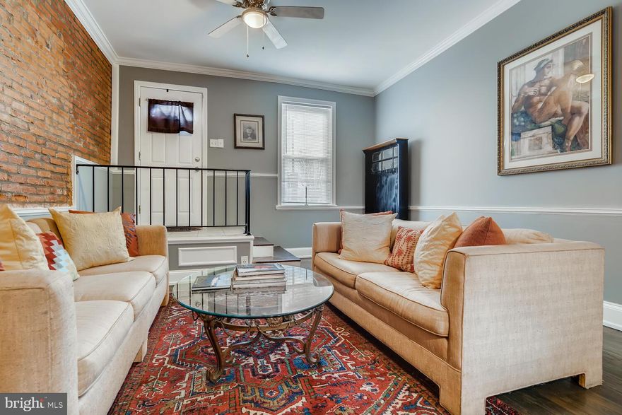 Located literally across the street from the B & O Rail Road Museum.  Bright end of group handsome Baltimore Row home.  Spacious residence with 1,770 above ground finished square feet. Wide & spacious entry living room featuring exposed brick walls, hardwood floors & soaring ceilings heights. This home is ideal for room mates and true entertainment. Living  room  neighbors updated kitchen that features  smooth white kitchen cabinets, stainless appliances & painted brick walls.  There is one window and a side entrance to the maintenance free rear decked yard.  2nd level offers two fully separated bedrooms on each end of the property.  Rear bedroom has easy access to deck overlooking fenced rear yard.  Front Bedroom feature two extra long windows that allows light to flow through easily. There are pleasant view of the B&O Train yard from your bedroom.  Full bathroom is centrally located in the hallway that is lined with closets for extra storage and laundry closet.  Third floor owners level features sitting area before double door entrance to bright Master bedroom.  Owner's full bathroom also located on this level.  This home is perfect for U of Md associate/student.  Easy stroll to professional schools, Inner Harbour, M&T stadium, downtown & transportation.   Home inspections are welcome for informational purposes only.  House is being sold "as is" with no know defects. Electric car charger excluded from sale**ground rent owner has never billed for the ground rent.  Believed to be unregistered ground rent.