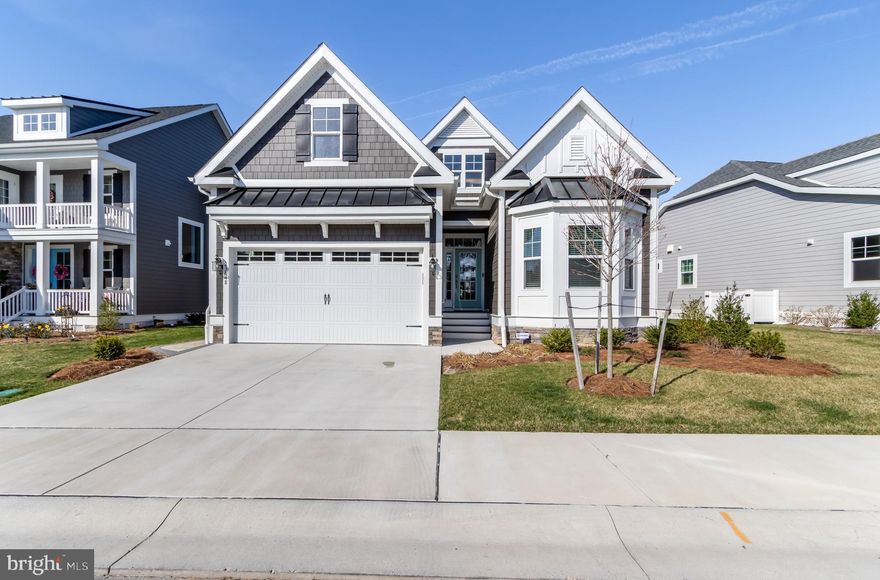 Welcome to refined coastal living at The Peninsula, one of Delaware’s most prestigious gated resort communities. Built in 2024 by Schell Brothers, this exceptional Bluebell home is perfectly situated on a tranquil pond and offers over 4,000 square feet of beautifully designed living space, blending luxury, comfort, and timeless style. Additional highlights include a finished basement with a full bath, beautifully designed outdoor living space overlooking the pond, and an owned solar energy system that adds both efficiency and long-term value to this exceptional home.

Thoughtfully designed with an open floor plan that blends comfort and functionality, the home offers 4 bedrooms and 4 full baths, including 2 bedrooms and 2 full baths on the main level, along with 2 additional bedrooms and 1 full bath on the second floor. One of its most desirable features is the finished basement with a full bath — a rare and valuable extension of the living space that offers incredible flexibility for a media room, game room, guest retreat, home gym, or additional lounge area. There is also an unfinished section that provides excellent storage or the opportunity to create even more custom space, along with attic storage for added convenience.

The first floor also includes a private home office, while the second level offers a spacious loft. At the heart of the home, the family room makes a stunning impression with a soaring ceiling and a gas fireplace framed by stone, creating a warm and inviting focal point.

The Professional kitchen is designed to impress with quartz countertops, a large center island, double wall ovens, a gas cooktop, stainless steel hood vent, and stainless steel appliances.

The main-level primary suite offers a luxurious retreat with two walk-in closets and a spa-like bath featuring a walk-in shower, while an upstairs bedroom also includes its own walk-in closet.

Outdoors, the expansive paver patio overlooking the pond, complete with a built-in grill and partially covered seating area, creates the perfect setting for entertaining or enjoying peaceful mornings and sunset evenings by the water.

As a resident of The Peninsula, you’ll enjoy an unmatched resort lifestyle with a Jack Nicklaus Signature golf course, elegant clubhouse, indoor and outdoor pools, wave pool, fitness center, spa, tennis, pickleball, walking trails, private beach area, kayak launch, and more.

This is more than just a home — it’s luxury coastal living in one of the area’s most exclusive communities.