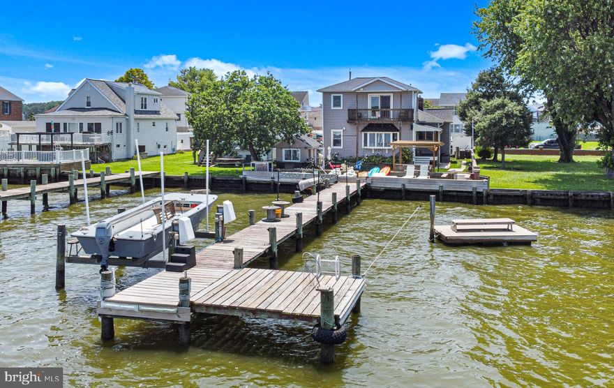 Gorgeous panoramic river views from this spacious two story home. Newly remodeled kitchen with plenty of storage, marble counters and elegant flooring. Beautiful hardwood floors throughout the main level. A separate dining room with a fireplace has a setting for cozy fall gatherings. The large family room has wonderful views of the bay overlooking Back River, Ballestone & Wildwood Beaches. Natural light in this home is abundant. The laundry area is located just off of the living room on the main level. Rounding out the main level are two spacious bedrooms and a full bath.  Amazing 2nd story primary suite with like views of the river and a balcony with panoramic views. Primary bath has massive walk in shower and no lack of vanity space. The lower level of the home is no let down when it come to storage space. Its waterproofed and has access to the 2 car oversized garage. The outside of the home is a vacation style setting with covered beach style seating area, fire pit and even has a crab shack/boat house style out building. The pier has electric service and boat lift. AC is 6 month old, Boiler is 2 years old. No need for vacations when living in this waterfront beauty!!!!