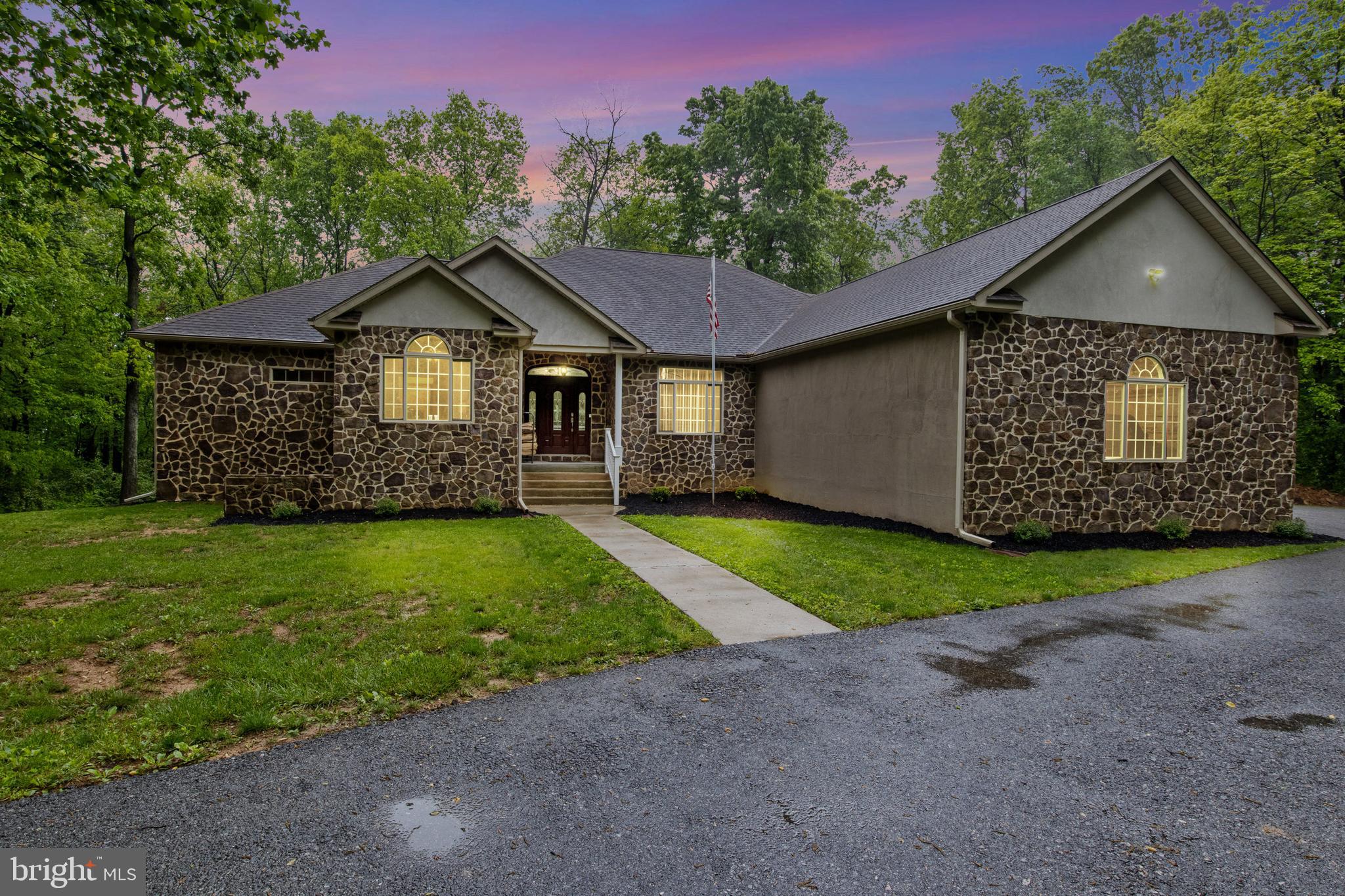 This approximately 3,132 square-foot house features three bedrooms and two and a half bathrooms. The spacious lot offers a charming exterior with lush landscaping and a stone exterior. A spacious garage and paved driveway provide ample parking.
The interior boasts a spacious layout with hardwood flooring throughout, allowing for abundant natural light. The primary bedroom is well-appointed with an expansive, elegant bathroom featuring ample counter space and storage.
The living areas are thoughtfully designed, with a focus on comfort and functionality. The home's expansive deck overlooking the wooded surroundings creates a peaceful, lush environment. The spacious yard and expansive grounds offer a scenic, countryside setting, complete with a covered porch for enjoying the tranquil wooded views.
The property is over 19 acres and is currently in clean and green. Come check out this immaculate home before it sells! The home also has a large 3-car garage. If you want even more garage space, fear not, there is also 2 pole barns! ONE OF A KIND!