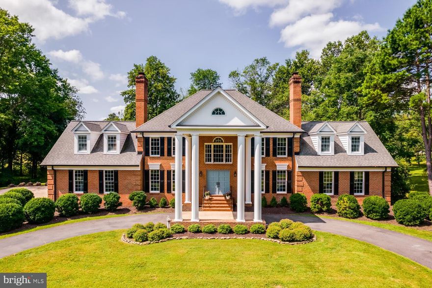 Nestled on 11 scenic acres in a lush Virginia valley, this traditional Georgian estate offers exceptional privacy, timeless elegance, and peaceful countryside views, all with modern conveniences just minutes away. Set well off the road, a long, tree-lined driveway leads to a classic circular drive and stately front entrance.
Enter through gorgeous double doors into a spacious main level featuring stunning hardwood floors, multiple family rooms, a formal dining room, and a spectacular back patio designed for effortless indoor-outdoor living. The updated gourmet kitchen is finished in a warm farmhouse style, blending charm and functionality. With an expansive 9-foot island, custom inlaid cabinetry, quartzite countertops, and reclaimed hardwood floors, this space is as beautiful as it is practical.
Upstairs, the expansive layout includes five bedrooms, three full bathrooms, attic access, and a formal den. The primary suite offers a thoughtfully designed, beautifully renovated bathroom. The upper second level features an additional bedroom with an en-suite bath, along with an adjacent room that could serve as a library or office.
In addition to the 6-bedroom, 5-bath main residence, the property features a 3-stall barn complete with water and electricity. A sport court for pickleball or basketball and a private pond further enhance the property’s exceptional appeal.
This remarkable estate is a rare opportunity to enjoy refined country living in an extraordinary setting. Welcome home to Thunder Road!