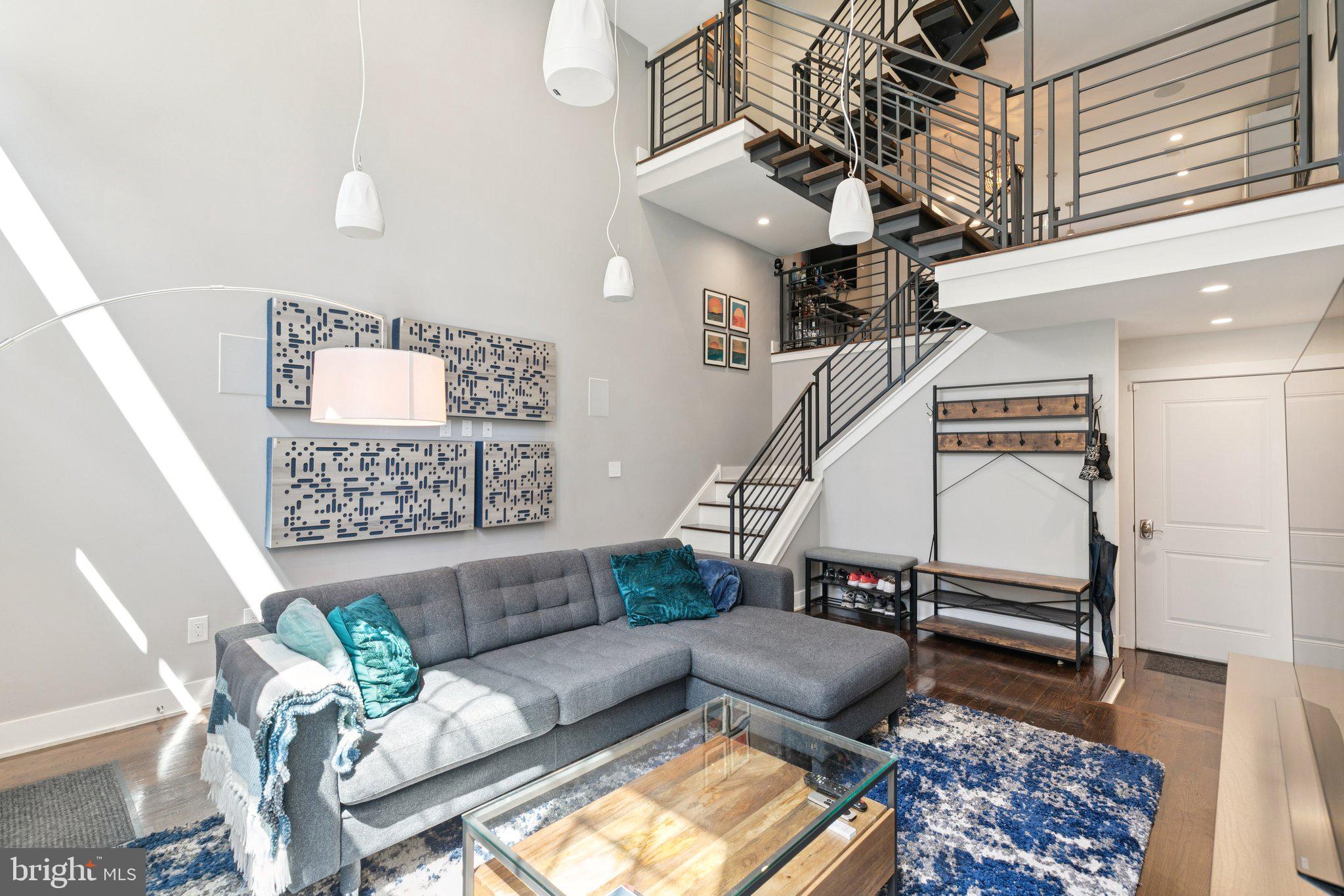 Welcome to 2407 Manton Street – a spacious 3-bedroom, 3-bathroom residence offering over 2,400 square feet of living space. Combining classic elegance with advanced smart home technology, this property features a thoughtfully designed floor plan, a private garage, and a stunning roof deck with sweeping skyline views—truly a rare gem in the city. From the street, the timeless brick façade and dramatic double-height windows preview the home’s remarkable interior. Once inside, natural light pours into the living room, accentuating the 16-foot ceilings, rich oak hardwood floors, and showstopping floating staircase. Overlooking the living room, the expansive kitchen and dining area provide the perfect setting for everything from cozy dinners to vibrant gatherings. The chef’s kitchen is a showstopper with a large center island wrapped in waterfall quartz, abundant shaker cabinetry, subway tile backsplash, and premium stainless-steel appliances. Upstairs, two spacious guest bedrooms offer generous closet space and share a stylish full bath with light gray and white tile and a modern vanity. A conveniently located laundry completes this level. The top floor is dedicated entirely to the primary suite, a private retreat with its own wet bar and refrigerator, an expansive walk-in closet, and a spa-inspired bath with double vanity, soaking tub, and open glass shower. Ascend to the rooftop oasis, where panoramic views of the Philadelphia skyline set the perfect scene for weekend get-togethers or a peaceful night to unwind. Downstairs, a fully finished basement offers another versatile living space for a gym, office or playroom. You’ll also find a full bath, a large utility storage room, and access to the attached garage which is equipped with an electric car charger. Smart upgrades throughout the home include Lutron motorized blinds, smart light switches, built in whole home audio (including the rooftop), and more. The location is just as impressive—steps from local favorites like American Sardine Bar, Porco’s, Small Oven Pastry Shop, and Dock Street Brewery, plus easy access to Passyunk Square, Graduate Hospital, Rittenhouse, and Fitler Square. Nearby grocery options include Aldi, Sprouts, Giant, Target, and Heirloom Market. With its seamless blend of elegance, modern technology, unbeatable location, and private parking, 2407 Manton Street is a home you won’t want to miss. Schedule your private tour today.