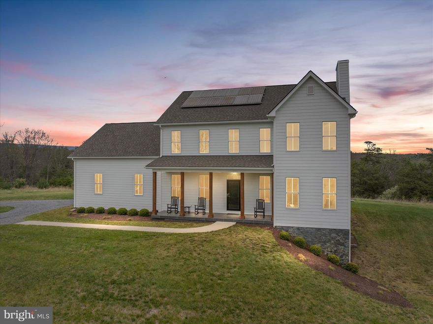 Stunning Modern Farmhouse Colonial with Breathtaking Mountain Views

Welcome to this exceptional modern farmhouse colonial, perfectly positioned to capture sweeping mountain views—especially from the inviting front porch. Nestled on a picturesque knoll, the home overlooks a tranquil pond and a landscape dotted with beautiful, stately homes. Enjoy frequent wildlife sightings and the peaceful charm of country living - And with high-speed fiber-optic internet, working from home is seamless—enjoy the serenity of country living without sacrificing modern connectivity.

This thoughtfully designed home features 4 bedrooms and 3 full baths, including a convenient main-level bedroom and full bath—ideal for guests or multi-generational living. The open, flowing floorplan offers both comfort and functionality, perfect for everyday living and entertaining.

Step outside to the incredible screened-in back deck—an ideal extension of your living space. Whether you're enjoying morning coffee, evening sunsets, or entertaining guests, this outdoor retreat offers comfort, privacy, and year-round enjoyment surrounded by nature.

Upstairs, you’ll find three spacious bedrooms, including a luxurious primary suite. The additional bedrooms are connected by a Jack & Jill bath, offering both privacy and convenience.

With 9-foot ceilings on all three levels, the home feels bright and expansive throughout. The partially finished lower level adds even more versatility, featuring a unique golf simulator (which can convey), a rough-in for a future full bath, and abundant storage space.

Eco-conscious buyers will love the fully paid-off solar panels, providing energy efficiency and long-term savings.  There is no HOA, but there is a $300/year road maintenance fee and deed restrictions.

This home truly has it all—style, space, views, outdoor living, and modern convenience. WOW! Don’t miss it!