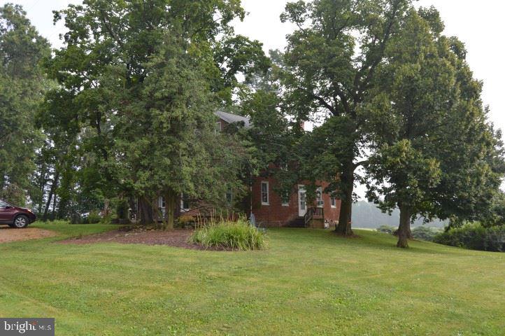 Enjoy country living in this 2 story brick home on 70+ ac's w/ mile frontage on Oppossum Creek - surrounded on several sides by land in Ag Preservation. Farm has an Agricultural Preservation Easement. 5 BR's, 4 FP's, new tankless water heater, new furnace & 3 heat zones - this home has been well maintained! Some farmland leased thru 2018 harvest season.