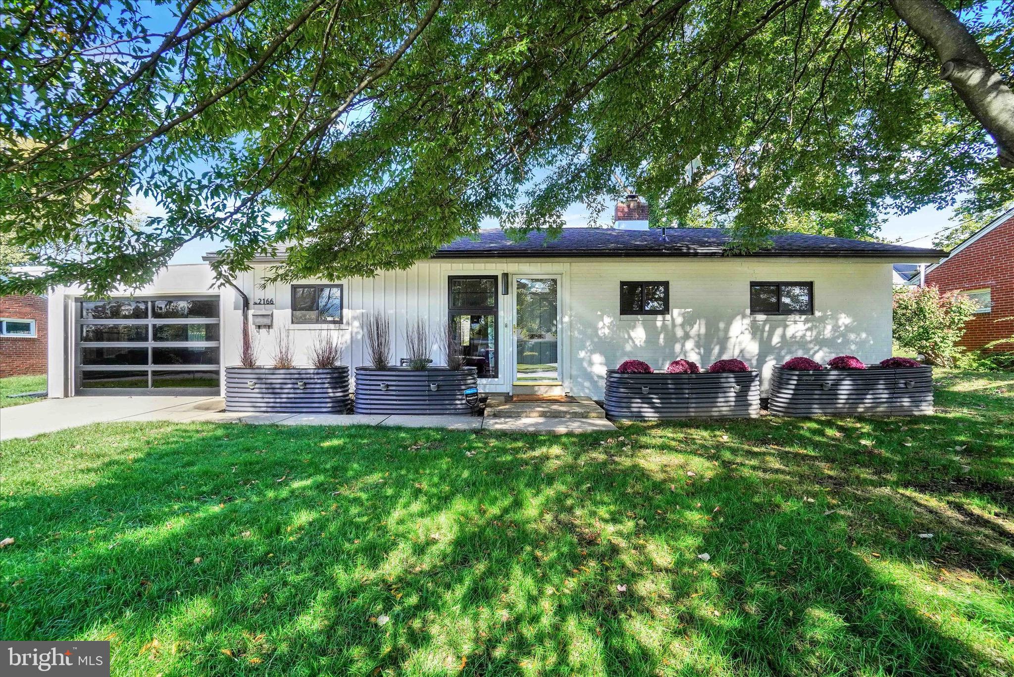 Move-in ready in the borough!  Enjoy your new home and all Camp Hill has to offer right away! This picture-perfect one-story home has been lovingly renovated inside and out with every modern update imaginable. Situated on an oversized .27-acre borough lot, this property shines with a new roof, gutters, windows, garage door, lawn, and landscaping. Step inside to a beautifully remodeled kitchen featuring ceiling-height cabinetry, rose-gold appliances, soft-close drawers, a tiled backsplash, recessed lighting, LVP flooring, and a buffet of cabinets with open shelving. The open-concept layout flows seamlessly into the spacious living room, complete with a cozy fireplace, custom slat wall, grasscloth wallpaper, pendant lighting, and a large picture window framing stunning yard views — the perfect place to enjoy all four seasons.
A versatile third bedroom offers flexibility, featuring pocket doors that open to the living room — ideal for a home office, guest room, or den. Both the front and back of the home feature custom 6x3 floor-to-ceiling windows with transoms that open outward, allowing a refreshing breeze even during a rain shower.
The bedrooms boast new carpet, updated lighting, and generous closet space. A newly built laundry area includes newer washer and dryer, soft-close cabinetry, and a movable island for added convenience.
The garage has been completely updated with tinted windows, epoxied flooring, and a custom smoked glass garage door. Enjoy peace of mind with central A/C, a security system, waterproofed basement, whole-house humidifier, and efficient gas heat. Storage is abundant with double-door closets in each bedroom, a large hallway closet, linen closet, hall closet, and basement storage. Experience exceptional outdoor living with multiple patios, a retractable awning, mature trees offering privacy, and a partially fenced yard. Just a short walk to Cornerstone Coffeehouse, Watershed Pub, local restaurants, the library, Willow Park, Fiala Field, and all Camp Hill schools.