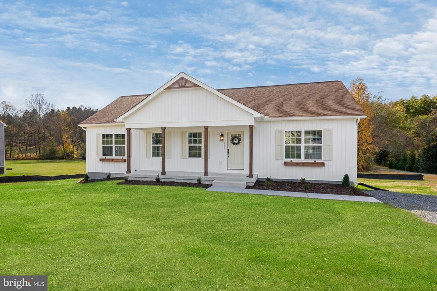 WARM WISHES AND BIG SAVINGS!      Scan the QR Code for current incentives! 
GOLF COURSE LOT – BRAND NEW CONSTRUCTION – READY FOR YOU TO CALL HOME!
Experience the perfect blend of modern design and timeless comfort in this brand-new 5-bedroom, 3-bath Rambler with a fully finished basement, set on over an acre in the desirable Tanyard Subdivision of Louisa County. Offering nearly 2,800 square feet of beautifully finished living space, this home is designed to impress.
Step inside to discover an open, light-filled floor plan enhanced by vaulted ceilings and luxury vinyl plank flooring throughout. The chef’s kitchen is a showstopper—featuring quartz countertops, stainless steel appliances, a farmhouse sink, and a large custom-colored island that’s perfect for cooking, entertaining, and gathering with family and friends.
The luxurious primary suite is a true retreat, showcasing a spa-inspired bath complete with a freestanding soaking tub and elegant finishes for the ultimate in relaxation.
The finished basement provides even more flexibility with a spacious recreation room, a full bath, an additional bedroom, and a bonus office or guest room—ideal for work, play, or hosting visitors.
Outside, you’ll love the expansive yard offering endless possibilities—whether you dream of outdoor entertaining, gardening, or simply enjoying peaceful golf course views.
This home delivers modern comfort, versatile living spaces, and the serenity of a prime location—making it the total package. Don’t miss your chance to make this beautiful property your own Home Sweet Home!