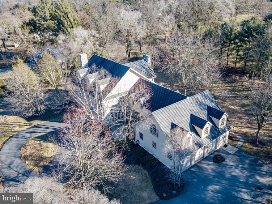 PERFECT HOME FOR AN EXTENDED FAMILY!  PRIME LOCATION IN THE HEART OF PRESTIGIOUS SAUCON VALLEY JUST ONE QUIET STREET FROM SAUCON VALLEY COUNTRY CLUB AND MINUTES TO HOSPITAL CAMPUSES.  Merryweather  is framed by mature trees and plantings, flagstone walkways and front and rear terraces. Inlaid wood floors, tiered crown moldings, pocket doors & true divided light windows accent rooms grand in scale for memorable entertaining yet warm & inviting for everyday living. Wood-burning fireplaces adorn the formal living room, sunken family room & lavish master bedroom suite. A sunlit kitchen shines w/white cabinetry, gleaming wood floors & a quartz center island. The private library is outfitted w/a cigar vent & built-in cabinetry. 5 spacious bedrooms, 3 full baths & 3 powder rooms will accommodate a bustling household and overnight visitors. Additional living space includes an expansive 2nd floor bonus room & a custom-designed lower level w/media/theater room, bar & exercise room.