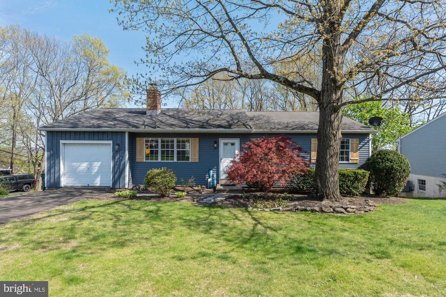 Welcome to 254 Parkridge Drive, Perkasie, PA — a home where craftsmanship, comfort, and character come together in a setting as stunning as the house itself. Nestled atop a gentle rise with sweeping views of Perkasie nestled in the valley below, this one-of-a-kind property offers a lifestyle as serene as the nature that surrounds it.

From the moment you arrive, you’ll notice that every inch of this home has been thoughtfully customized. Handmade cedar shutters frame the exterior with warmth and charm, hinting at the artistry that continues inside. Step through the front door and into a living space that feels both welcoming and refined, where shiplap walls and a rich brick fireplace create a cozy, textured backdrop for everyday life. The open layout flows seamlessly from the Living Room into the Kitchen and Breakfast Area, thanks to a thoughtfully placed pass-through that enhances the sense of space and connection.

In the kitchen, glazed cabinetry pairs beautifully with a generous pantry, marrying style with function. Just beyond, the Dining Room features built-in corner cabinets and opens onto a beautiful Trex deck — the perfect place to unwind and take in panoramic views of rolling hills, mature trees, and the peaceful charm of Perkasie’s natural landscape. Whether it’s golden hour or a crisp fall morning, the view from this deck is a daily reminder of the beauty of Bucks County.

The main bedroom is a peaceful retreat, complete with its own private half bath, while the lower level of the home offers even more to love. Mostly finished and full of potential, the walk-out basement boasts a handcrafted bar area that’s ideal for entertaining, with sliding doors that lead directly to the outdoors. There’s plenty of room to expand — envision adding a bathroom, extra bedrooms, or a full guest suite to suit your needs and dreams.

With a newer heat pump and central air system, comfort is guaranteed year-round. And with a smart combination of first-floor living and the opportunity for creative expansion below, this home truly offers the best of both worlds — turnkey convenience with room to grow. Outside, leaf covers on the gutters provide ease of mind . You don't want to miss this beautiful home!