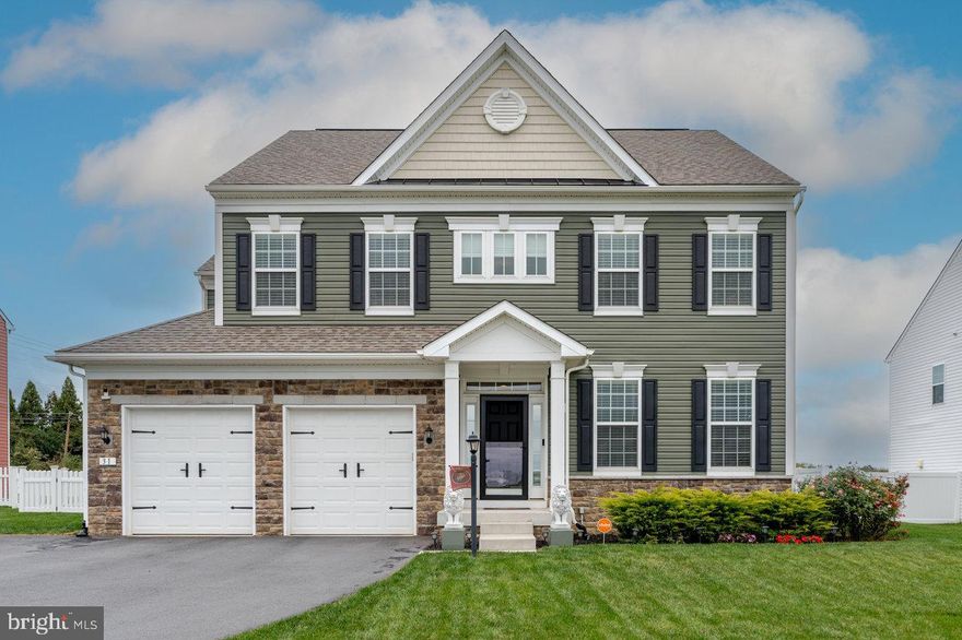 Nestled in the prestigious Aspen Greens community of Jefferson County WV, this exquisite Executive Colonial residence, built in 2019, epitomizes luxury living. Spanning over 3,500 sf above grade and nearly 1,300 sf finished in the lower level for nearly 5,000 total finished living space, this home boasts four spacious bedrooms and four and a half elegantly appointed bathrooms, each featuring high-end finishes and thoughtful design. Step inside to discover an open floor plan that seamlessly integrates the gourmet kitchen, complete with upgraded countertops, a large island, and top-of-the-line appliances, including a built-in microwave, wall oven, and a down-draft cooktop. The family room, adorned with a stunning stone fireplace, invites warmth and comfort, while the formal dining area, enhanced by crown moldings and chair railings, sets the stage for sophisticated gatherings. Retreat to the primary suite, where two lavish walk-in closets and a spa-like bathroom with a walk-in shower and soaking tub await. One of the four bedrooms is a Princess Suite with attached private full bath and walk in closet.  Additional interior highlights include recessed lighting, built-ins, and a convenient upper-floor laundry. The exterior is equally impressive, featuring extensive hardscaping, beautifully landscaped grounds, and inviting patio and porch that provide serene outdoor spaces for relaxation. The property sits on a generous 0.38-acre lot, offering a level, fenced rear yard perfect for entertaining or enjoying peaceful moments. With an attached two-car garage and ample driveway parking, convenience is paramount. The community amenities, including well-maintained sidewalks and jog/walk paths, enhance the exclusive lifestyle this home offers. Experience the perfect blend of luxury, comfort, and modern living in this remarkable property.