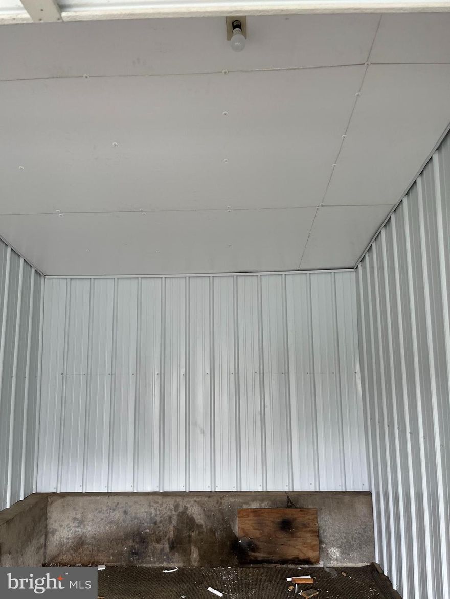 Large 1 Car garage space with newly installed metal siding on the interior.