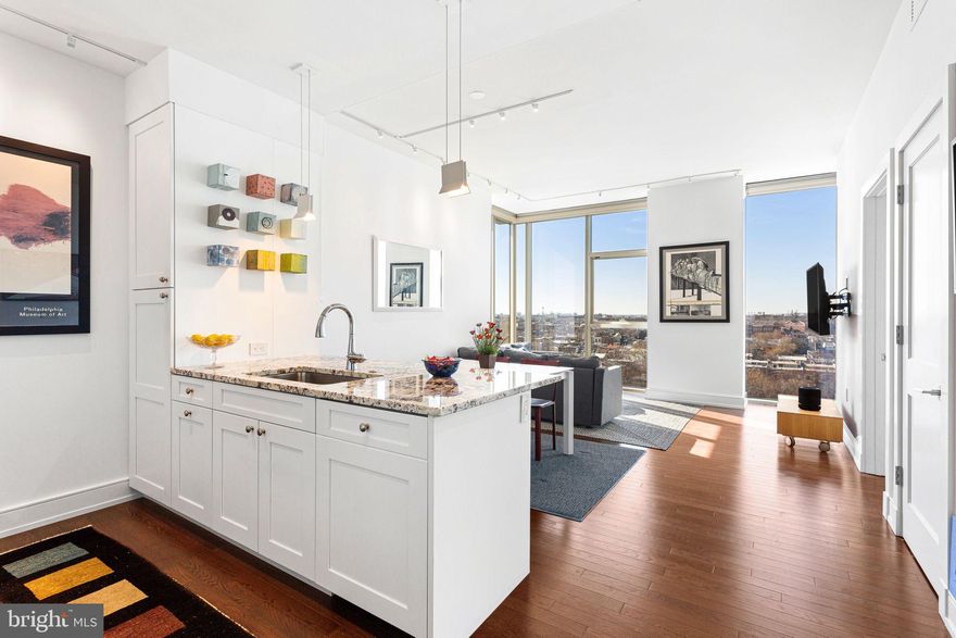 Amazing opportunity to live at One Riverside Condominiums for less than one million dollars! Perched on the highest floor available for a one-bedroom, Residence #905 offers panoramic east, south, and west views that sweep from the city skyline to the Schuylkill River and Park. This rare 1BR, 1.5BA home is one of only three in the building. This unit comes with on-site parking and a storage unit—a combination unmatched in Philadelphia’s luxury condo market. Chef’s kitchen with Sub-Zero refrigerator, Wolf cooktop/oven, large pantry and granite-top island. Custom California Closets in the bedroom and entry, plus Lutron smart shades and lighting for effortless control of light and privacy, plus other smart home features. Marble-clad baths for timeless sophistication. One Riverside is a five-star, full-service building with 24-hour concierge, valet parking, chauffeur-driven town car, and an array of resort-level amenities: heated 60' indoor lap pool, Peloton-equipped fitness center, saunas and steam rooms, club room with catering kitchen, boardroom, guest suite, landscaped garden in front plus back terrace with outdoor kitchen, grill, television and seating for al fresco dining. Situated in the exclusive Fitler Square neighborhood, you’re steps from the Schuylkill River Trail, Rittenhouse Square, acclaimed restaurants, UPenn, HUP, Drexel, 30th Street Station, and cultural attractions. Tax abatement through May 2027. The monthly parking fee is $310 (additional $30/month for electric cars). Includes storage unit #25. This is more than a home — it’s the highest expression of One Riverside living.