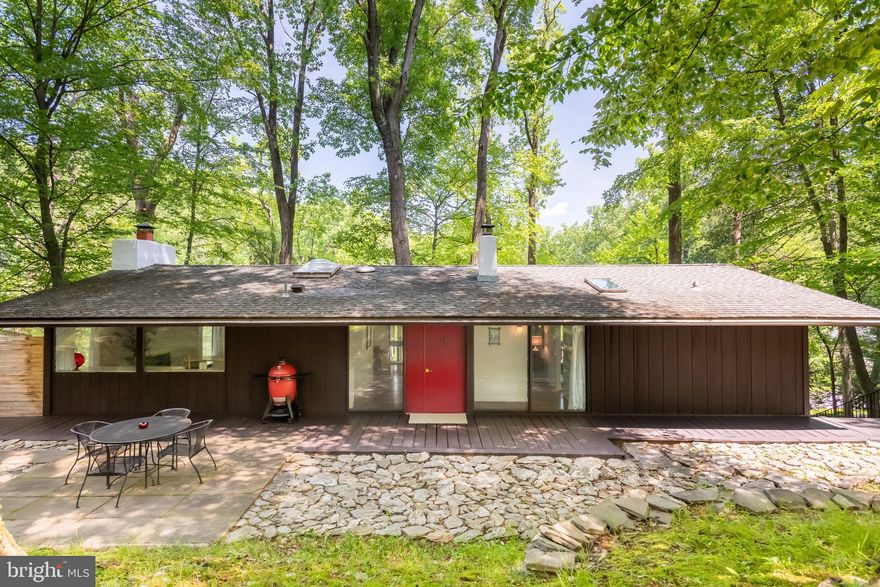 Welcome to 244 Vincent Road, Paoli, PA — a pristine Robert McElroy-designed mid-century modern home in the award-winning Tredyffrin-Easttown School District. Lovingly restored and renovated with deep respect for its architectural heritage. This home offers a rare opportunity to own a residence cohesively designed throughout staying true to its mid-century modern roots. Every detail reflects thoughtful care and research preserving the home’s signature clean lines and seamless indoor-outdoor flow. One enters the home through an open concept foyer area. The main living and dining area centers around a classic wood-burning fireplace and opens to both the screened-in porch and covered front deck, ideal for relaxing or entertaining.The 2022 kitchen renovation is a standout, blending timeless elegance with modern functionality. It features Danby Montclair marble countertops, a professional-grade Aga Elise 48” induction range, Bertazzoni vent hood, Café refrigerator and dishwasher, a charming farmhouse sink, subtle and ample cabinets and a skylight above the custom center island that fills the space with natural light. A striking subway tile backsplash extends from counter to ceiling, adding bold texture and a compelling visual anchor. The home’s outdoor spaces include a unique screened-in front porch that extends out from the second floor, an expansive covered front deck running the length of the house and a private rear facing deck for al fresco dining or grilling with a bluestone patio accented by natural stone beds, creating an organic and serene retreat. The sumptuous owner's suite features a huge walk-in closet designed by California Closets.The stunning main-level bathroom includes elegant Carrara marble flooring and countertops, a double vanity, floor-to-ceiling wall tile, and a gorgeous shower/tub with dual access via a sliding door—serving as both a private en-suite for the owner’s bedroom and a sophisticated hall bath for guests. A skylight drenches this bathroom in natural light.The lower-level family room offers sliding glass doors to the front facing patio area.Three additional bedrooms are situated on the corners of the home, each of which could easily serve as a home office. The lower-level bathroom showcases Carrara marble, floor-to-ceiling subway tile and a frameless glass shower door continuing the home’s elevated modern style.The laundry/utility room is impressively appointed with a high-end stainless steel utility sink, a folding counter atop a built-in cabinet and pristine finishes—providing a great space for even the most ordinary household tasks.The original white oak floors upstairs were sanded and refinished in 2022 for the first time, while matching white oak was installed on the lower level—creating a seamless, warm flow throughout. Custom California Closets were added throughout the home in 2024 optimizing storage, while Google Nest thermostat and fire detectors add smart home convenience. Sunlight and serene views fill every window, reinforcing the home’s connection to nature and Robert McElroy's architectural aesthetic and signature design details. A two-car garage, professionally landscaped grounds, and multiple outdoor living areas complete this exceptional property. Just minutes from the Paoli train station and the shops and restaurants of the Main Line, this home offers the perfect combination of architectural integrity, modern comfort, and a tranquil setting. A discerning buyer will fall in love with this move-in ready, architecturally significant and lovingly updated home — a very special place to call your own. Welcome home.