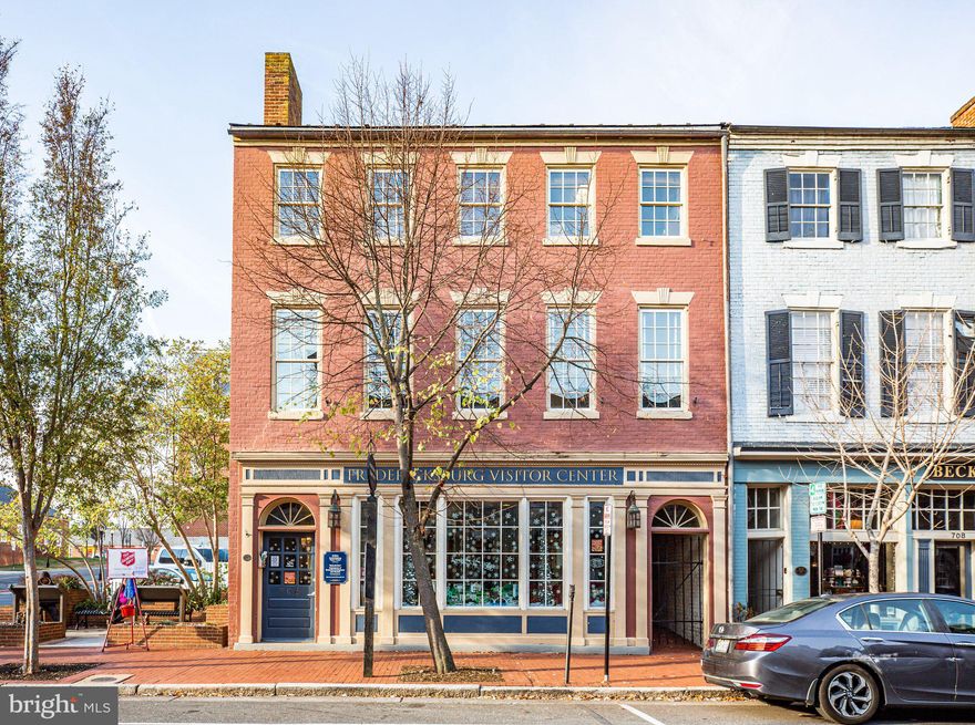 Fredericksburg’s Economic Development Authority (EDA) owns this historic property in the heart of downtown Fredericksburg. It’s within a block of Riverfront Park, the Sophia Street Parking Garage, the Courtyard by Marriott hotel and dozens of restaurants, art studios, and retail  shops. This is truly a one-of-kind opportunity. 
 This sale includes a 5,319 SF building and a 14 space parking lot.  Currently leased by the City of Fredericksburg for The Visitor Center and the Economic Development and Tourism Office for up to 24 months as they build out their new location, this gives the new owner time to plan and get approved any new construction while it is fully leased. 
Built in 1824 and used originally as a confectionary shop and residence, there were extensive renovations done in 1975 and designated as the "Bicentennial Center"! The front of the building consists of three levels with the visitors center on the main floor and two floors of office space above. There is a large meeting room on the main floor and a large storage area. In the back of the building there is a small 2nd floor office space with a 1/2 bath. There are 2 public bathrooms accessible from the exterior only that must remain public during the lease period only.  The 14 space parking lot creates lots of opportunity for creative use of space.