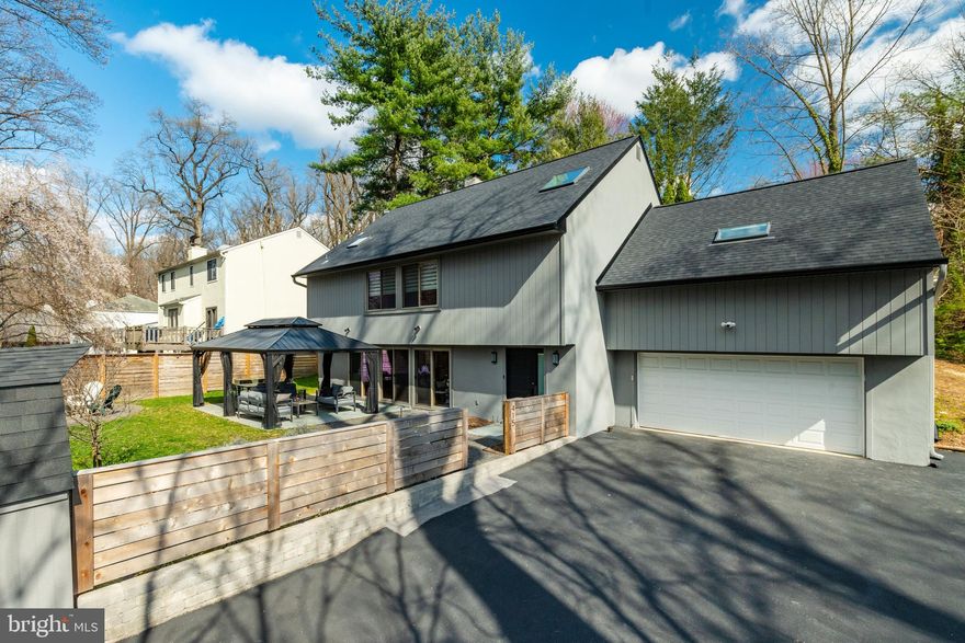 Set on a gracious lot with tree top views in sought after Penn Valley, this stylish 4 bedroom, 3.5 bathroom home, boasting over 3,100 square feet of bright and airy living space will delight you. As you enter, a 2-story foyer sets the stage for contemporary living with an abundance of light, windows, and modern updated finishes.  The main level features an open-concept living and dining area, anchored by a wood-burning fireplace with brick surround, hardwood floors, and a wall of sliding glass doors that take you to fantastic outdoor living spaces. Outside in the fully fenced-in yard is a large flagstone patio with pergola and fire pit, the perfect place to entertain guests or enjoy an early evening cocktail. The heart of the home, the updated kitchen, features granite countertops, stainless steel appliances, sleek cabinetry, ceramic tile backsplash and a peninsula with seating for four - perfect for a casual meal!  A spacious laundry room with built in cabinetry and counter space is adjacent to the kitchen and offers great storage.  The mudroom has a bench and cubbies and is conveniently located off of the 2-car garage.  An updated powder room and large coat closet complete the first floor for ultimate functionality. Heading upstairs you will find a luxurious primary bedroom retreat with a new en-suite bathroom boasting a skylight, double sink with quartz countertops, a frameless glass shower, and linen closet.  A built-in vanity with granite top, wall of closets and a custom outfitted walk-in closet complete this fabulous primary suite. The second floor features two additional bedrooms each with generous sized outfitted closets, and an updated hall bathroom with a double vanity and tub/shower combo. A large family room space offers a great option for a kids playroom, media room, or a home office! The third floor presents a fourth bedroom with an en-suite bathroom, skylights, expansive walk-in closets (one currently used as a workout room), with its own HVAC system perfect for guests, a nanny or a home office. With a new roof, gutters, lighting, carpet, bathroom fixtures and a fresh coat of paint inside and out, this home is ready for new owners to move right in! All of this is located in the award-winning Lower Merion school district, within walking distance to General Wayne Park and downtown Narberth, as well as major roadways and public transportation.