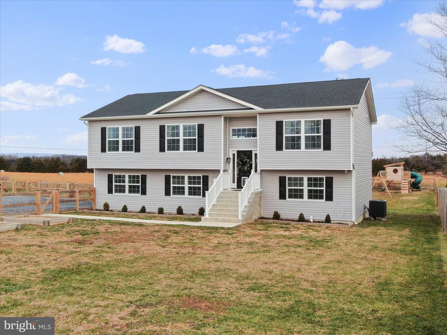 Why wait to build, move in ready! Spacious 4BR 3BA Split Level on Unrestricted .42 acre lot. Fully fenced yard for extra safety; rear yard backs to farm land; playground equipment to convey. Nearly new inside, build in late 2023.  Fully finished lower level with extra bedroom and another recreation room. Oversized 2 car garage. Must see to appreciated!