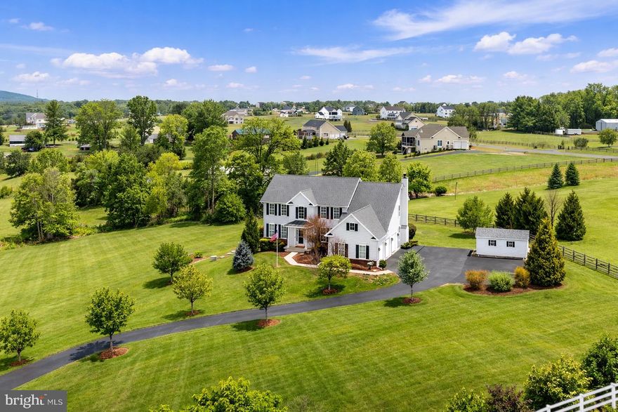 This one checks all the boxes. Nestled in a private enclave of just 12 homes on spacious homesites, this property offers the rare combination of privacy, scenic views, and country living — all without the restrictions or expense of an HOA. Set on beautiful acreage with sweeping views of Loudoun’s rolling hills, there’s plenty of room to spread out, garden, or even bring your chickens and enjoy the best of country life — just 15 minutes from the boutique shops, restaurants, and small-town charm of downtown Leesburg and in the heart of Loudoun’s renowned winery and brewery region.  So many updates including:  new 2-zone HVAC for the main and lower level, new carpet throughout, brand new finished walk-out lower level, smart thermostats and more.  

The main level offers exceptional flexibility to suit a variety of lifestyles. A private room with a full bath can serve as a true main-level bedroom for guests or multi-generational living, while a second room with glass French doors and a Juliet balcony overlooking the yard and distant hills can function beautifully as a home office, library, or additional sitting room. Together, these spaces create multiple options for working from home, hosting guests, or designing the layout that best fits your needs.

The kitchen features recessed lighting, white 42” cabinetry, and a center island ideal for gathering. It opens to a large deck with stairs leading down to the fully fenced backyard and surrounding landscape. The outdoor space is designed for enjoying the peaceful setting, featuring a stamped concrete patio and firepit area, along with a private hot tub—perfect for relaxing evenings under the stars while taking in the beautiful views of Loudoun’s rolling hills. The kitchen also flows into the inviting family room with built-in speakers and a wood-burning fireplace, while a bright sunroom provides the perfect spot for reading, relaxing, or informal entertaining.

Upstairs, the spacious primary suite offers two walk-in closets and a luxury ensuite bath with double vanities, a large soaking tub, separate walk-in shower, and enclosed water closet. A princess suite includes its own private bath, while two additional bedrooms, each with their own walk-in closets share a third full bath with a double-bowl vanity and tile-surround tub/shower.

The newly finished walk-out lower level expands the home’s living space with a large recreation area with a wet bar rough in ready for your own selection, plus an additional bedroom with a fifth full bath—ideal for overnight guests, an au-pair suite, or extended family. Ample unfinished areas provide excellent storage.  

Outside, a 10' x 20' raised garden bed is perfect for your own tomatoes and peppers, or grow your own herbs and spice plants, while a large shed fits whatever gardening and outdoor tools and toys, and an oversized driveway pad fits multiple vehicles or serves as a great play area for the little ones.

Homes like this are rarely available—beautifully situated on multi-acre homesites in small, quiet neighborhoods without HOA restrictions. Enjoy the Loudoun lifestyle on your own terms, surrounded by scenic countryside and vineyards, while remaining just 15 minutes to downtown Leesburg, 32 minutes to Dulles International Airport, and approximately 35 minutes to the major tech corridor of Reston and Herndon.